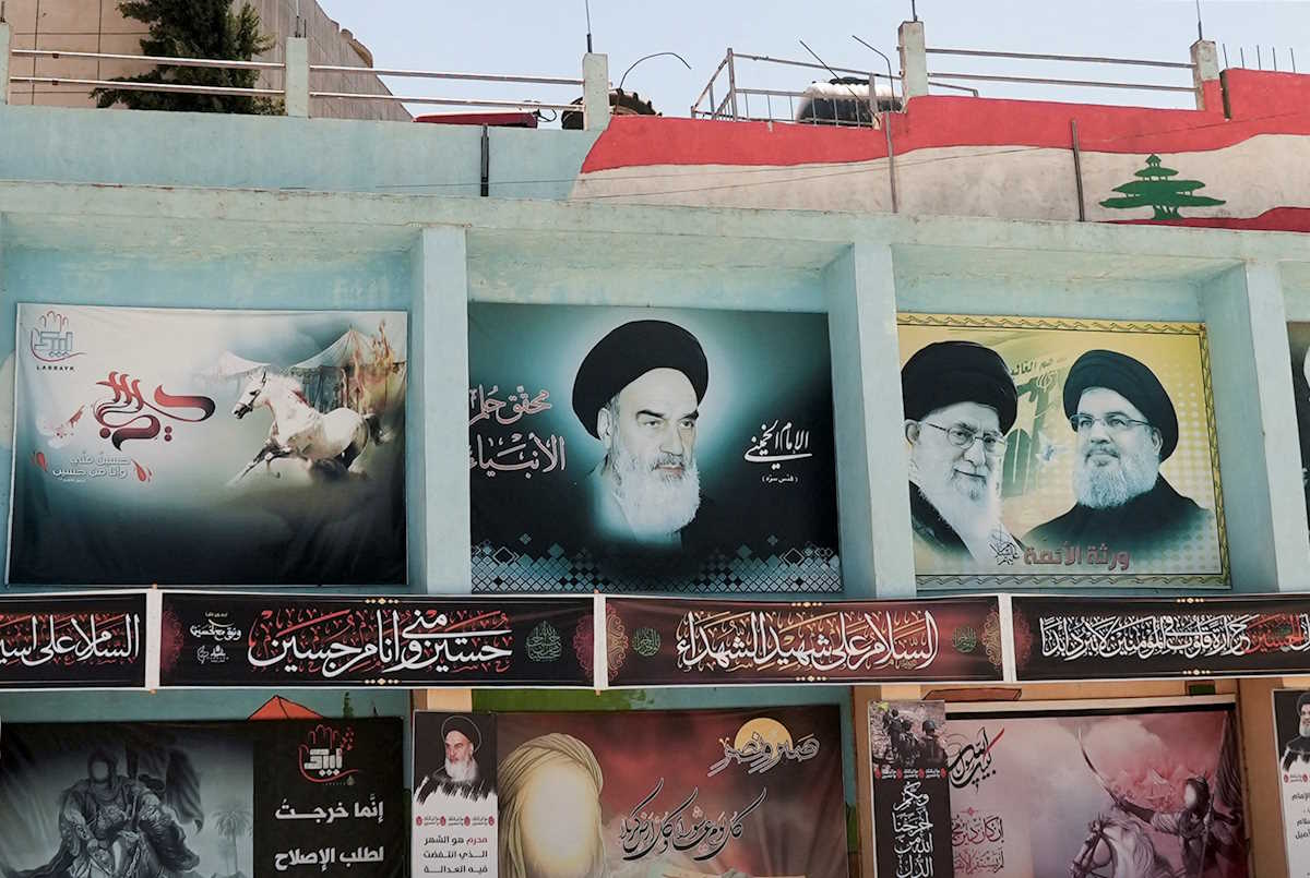 FILE PHOTO: A view of banners depicting Iran's late leader Ayatollah Ruhollah Khomeini, Iran's Supreme Leader Ayatollah Ali Khamenei and Lebanon's Hezbollah leader Sayyed Hassan Nasrallah in the town of Yaroun, southern Lebanon August 15, 2022. REUTERS