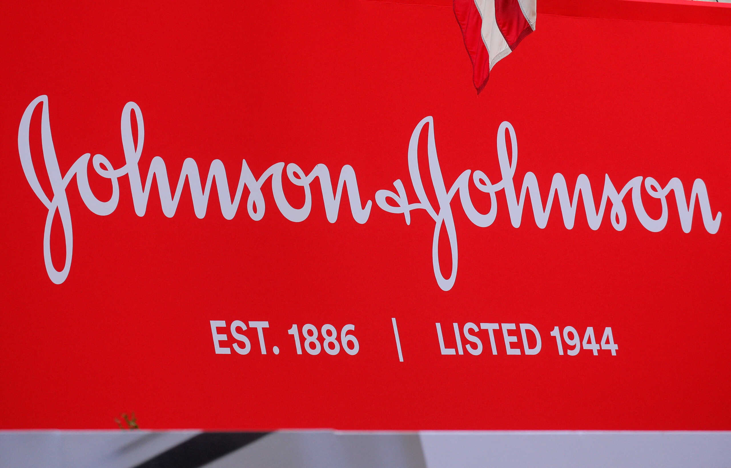 FILE PHOTO: The company logo for Johnson & Johnson is displayed to celebrate the 75th anniversary of the company's listing at the New York Stock Exchange (NYSE) in New York, U.S., September 17, 2019. REUTERS