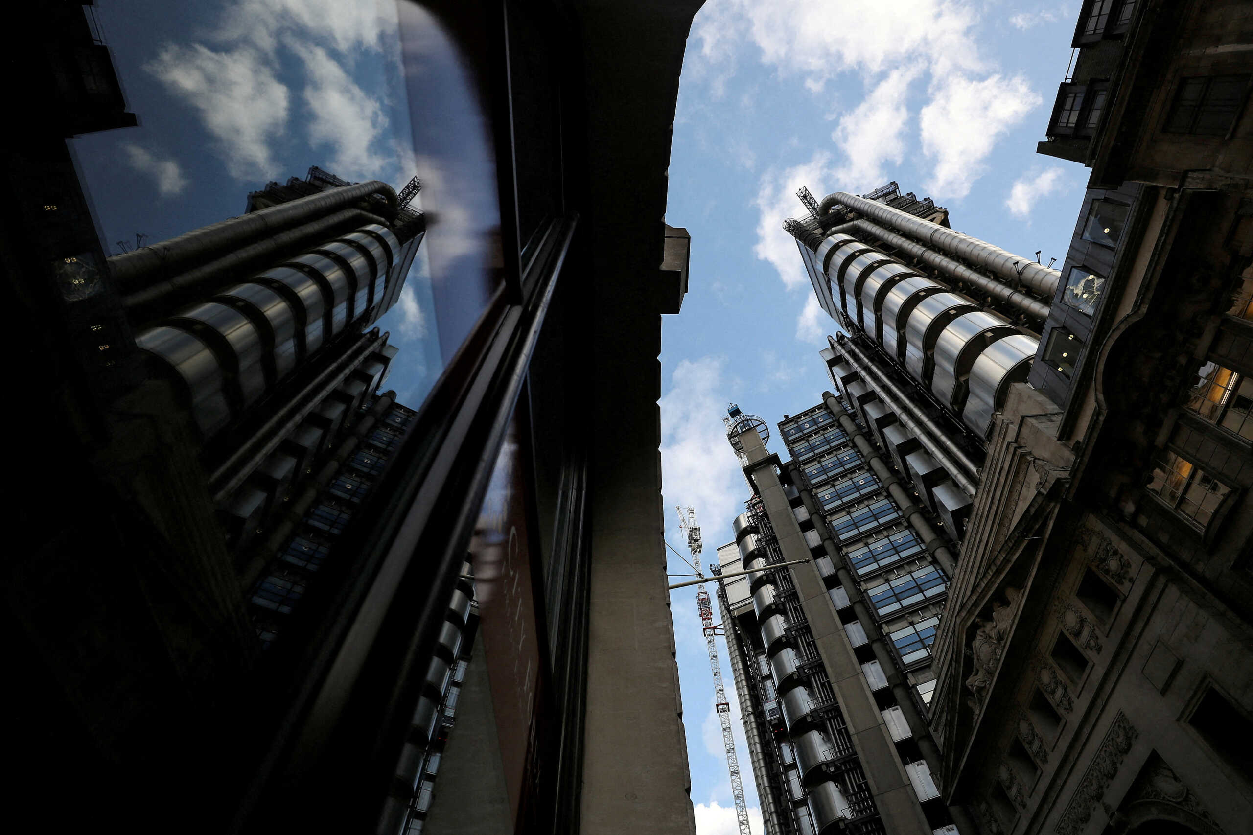 FILE PHOTO: The Lloyd's of London building is reflected in a window in the City of London financial district in London, Britain, February 1, 2018. REUTERS