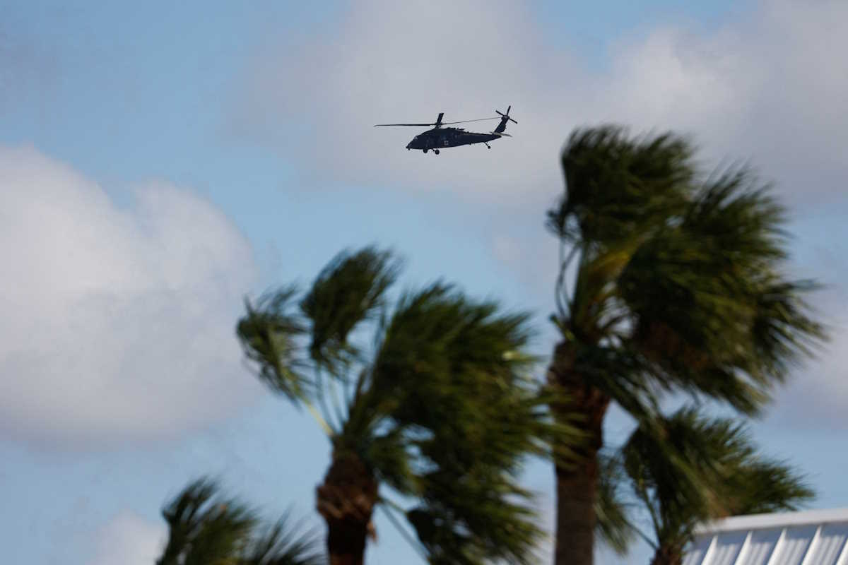 A rescue helicopter flies over an area affected by Hurricane Milton after it made landfall, in Venice, Florida, U.S., October 10, 2024. REUTERS