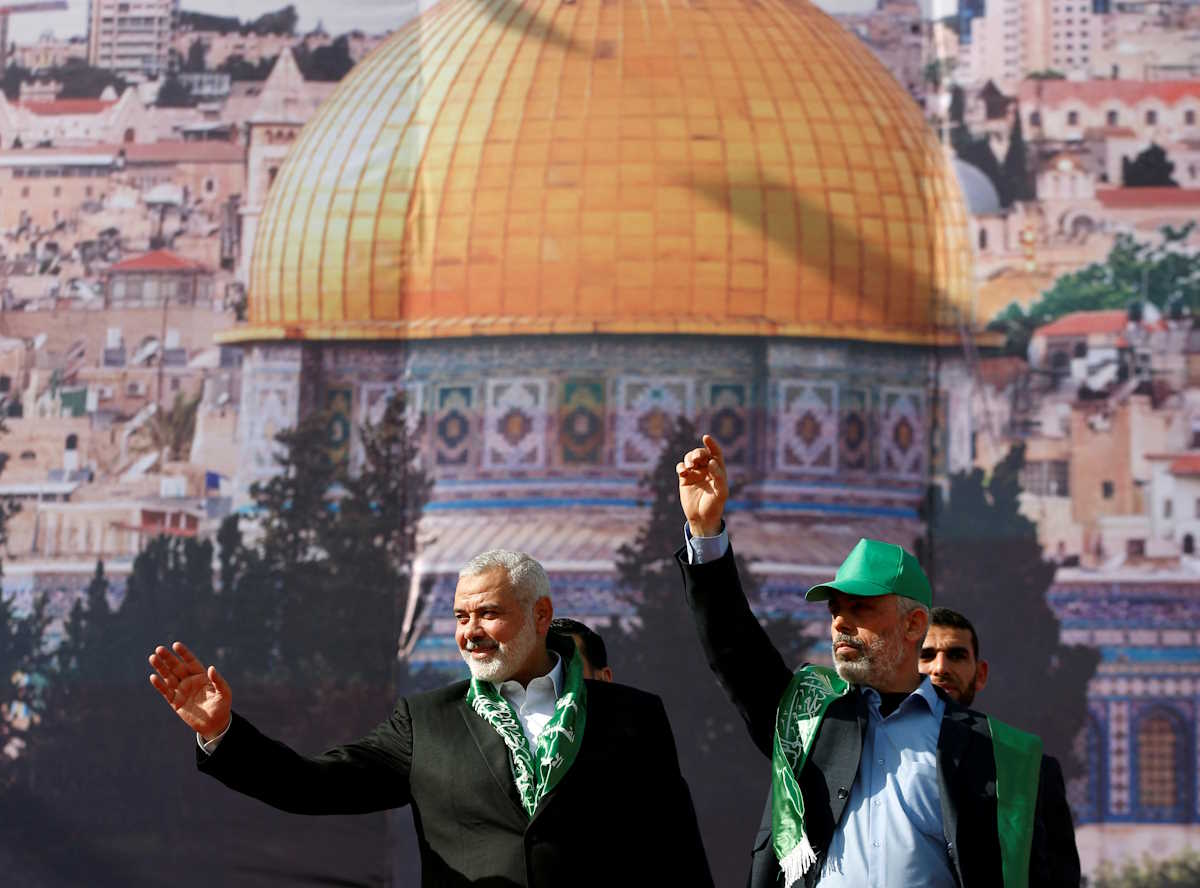 FILE PHOTO: Hamas Chief Ismail Haniyeh and Gaza's Hamas Chief Yahya Sinwar gesture to supporters during a rally marking the 30th anniversary of Hamas' founding, in Gaza City December 14, 2017. REUTERS