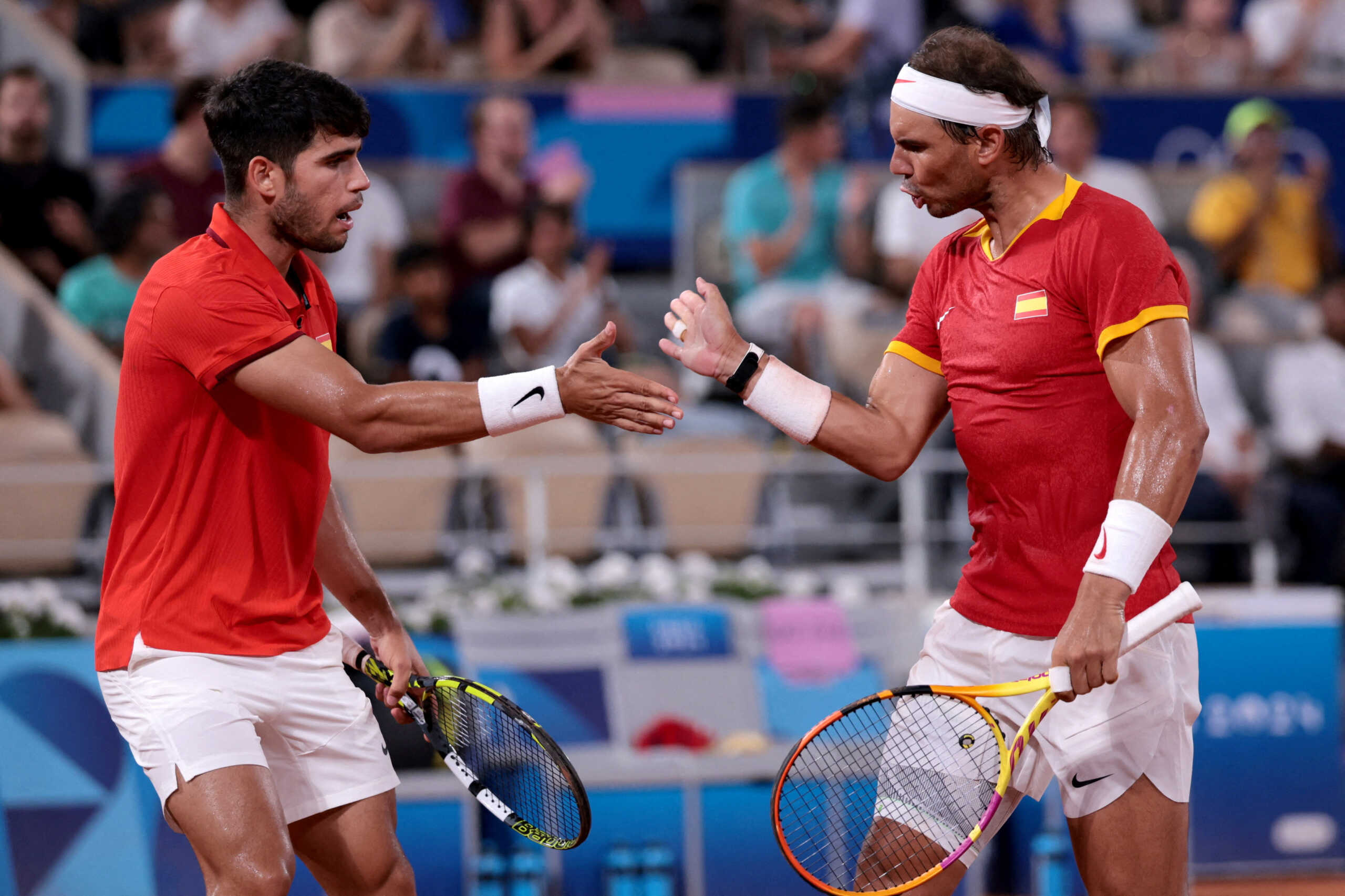 FILE PHOTO: Paris 2024 Olympics - Tennis - Men's Doubles Quarterfinals - Roland-Garros Stadium, Paris, France - July 31, 2024. Carlos Alcaraz of Spain and Rafael Nadal of Spain react during their match against Austin Krajicek of United States and Rajeev Ram of United States. REUTERS