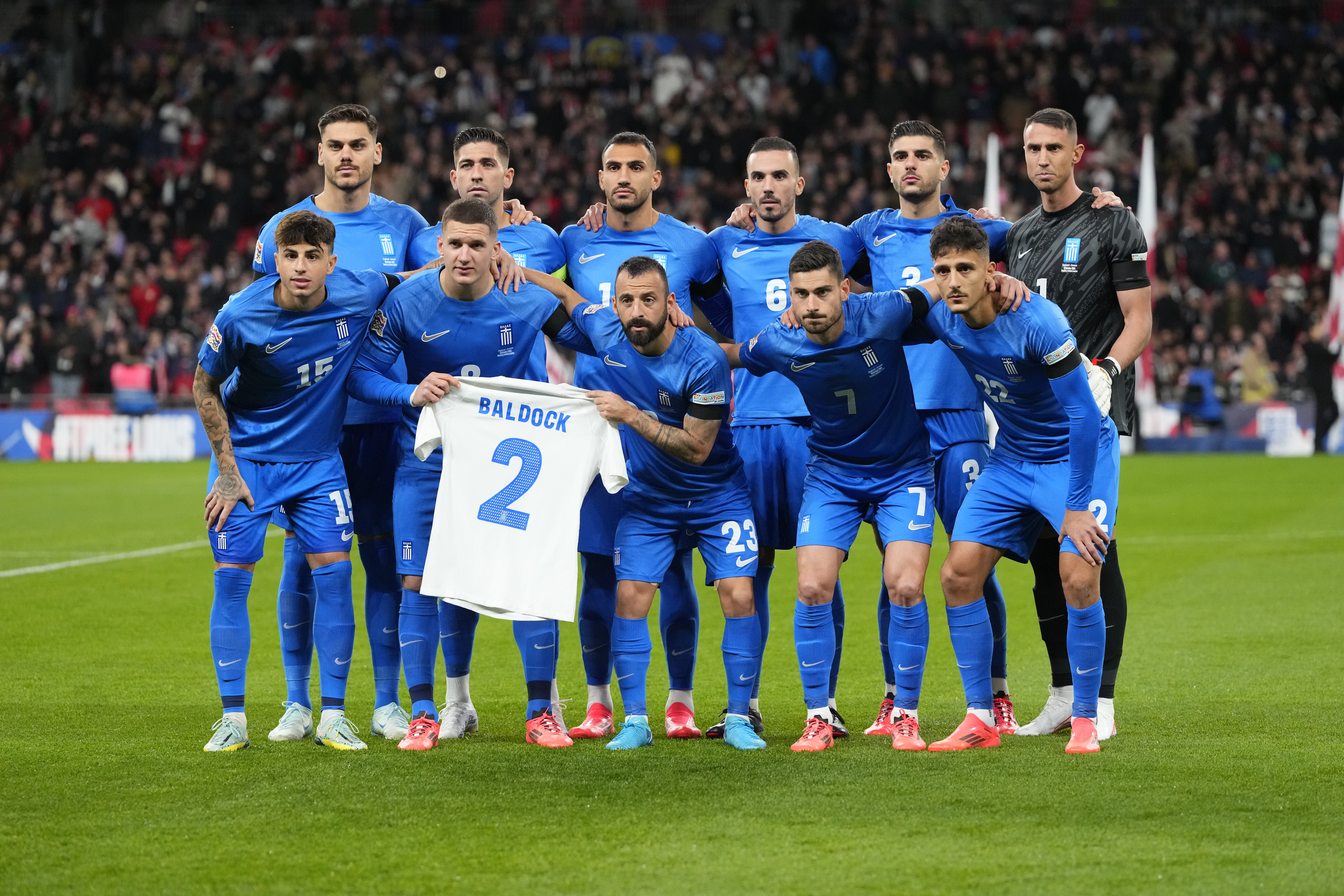 Greece's team players pose for a picture with a t-shirt in tribute to George Baldock before the UEFA Nations League Group F soccer match between England and Greece at Wembley Stadium in London, Thursday, Oct. 10, 2024. England-born Greece international and Panathinaikos defender George Baldock, who had previously played for Sheffield United, has been found dead in his Athens home on Wednesday. (AP Photo