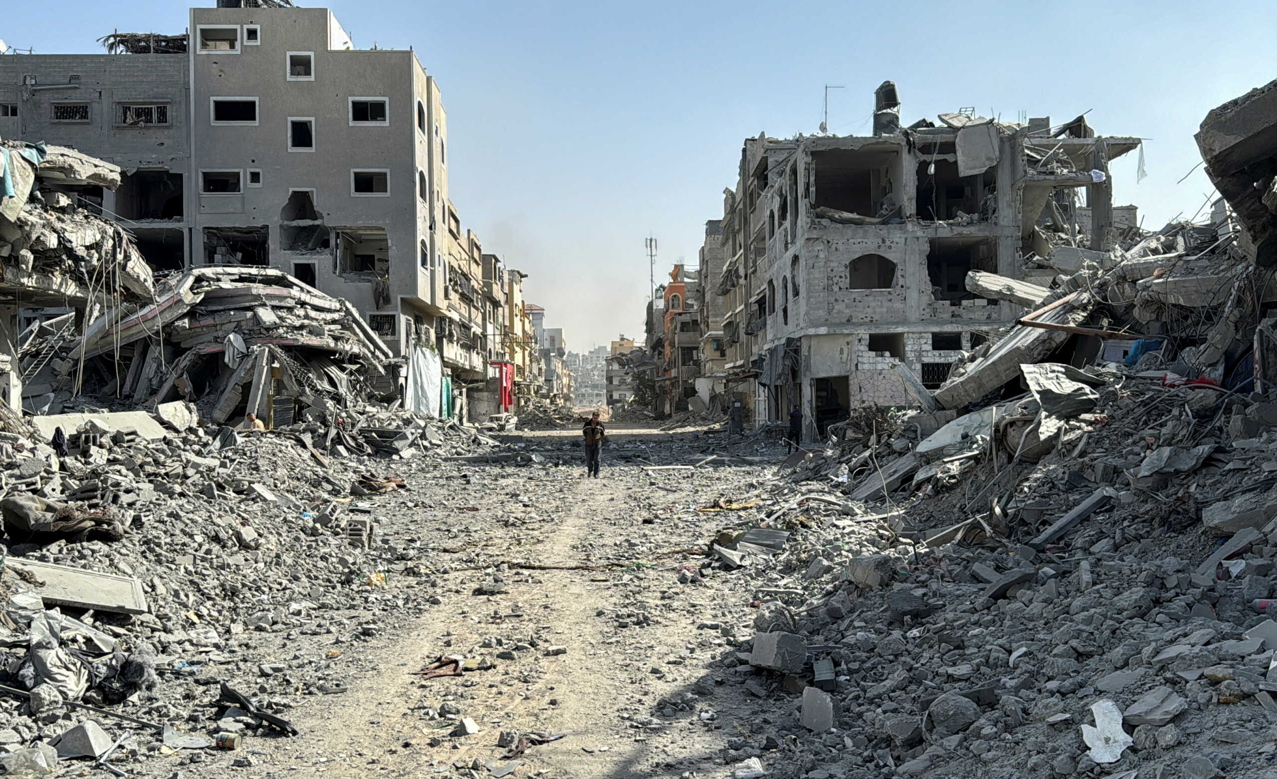 A Palestinian man walks past the rubble after Israeli forces withdrew from the area around Kamal Adwan hospital, amid the ongoing Israel-Hamas conflict, in Jabalia, in the northern Gaza Strip October 26, 2024. REUTERS