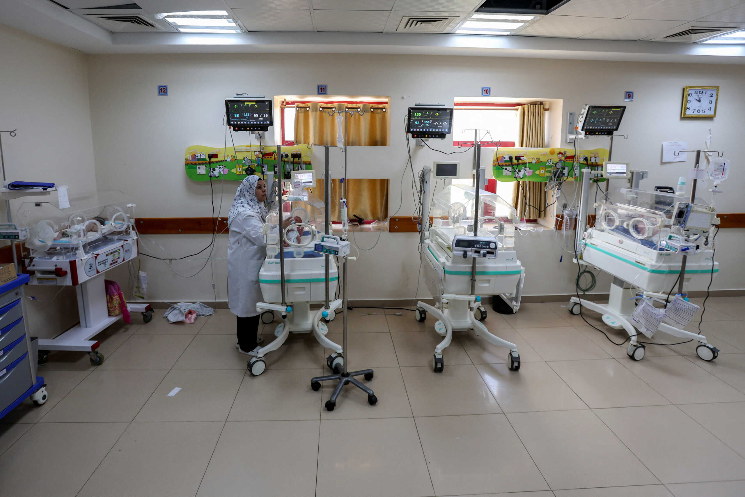 A Palestinian nurse feeds a newborn in an incubator, amid the Israel-Hamas conflict, at a hospital in Deir Al-Balah in the central Gaza Strip, September 10, 2024. REUTERS