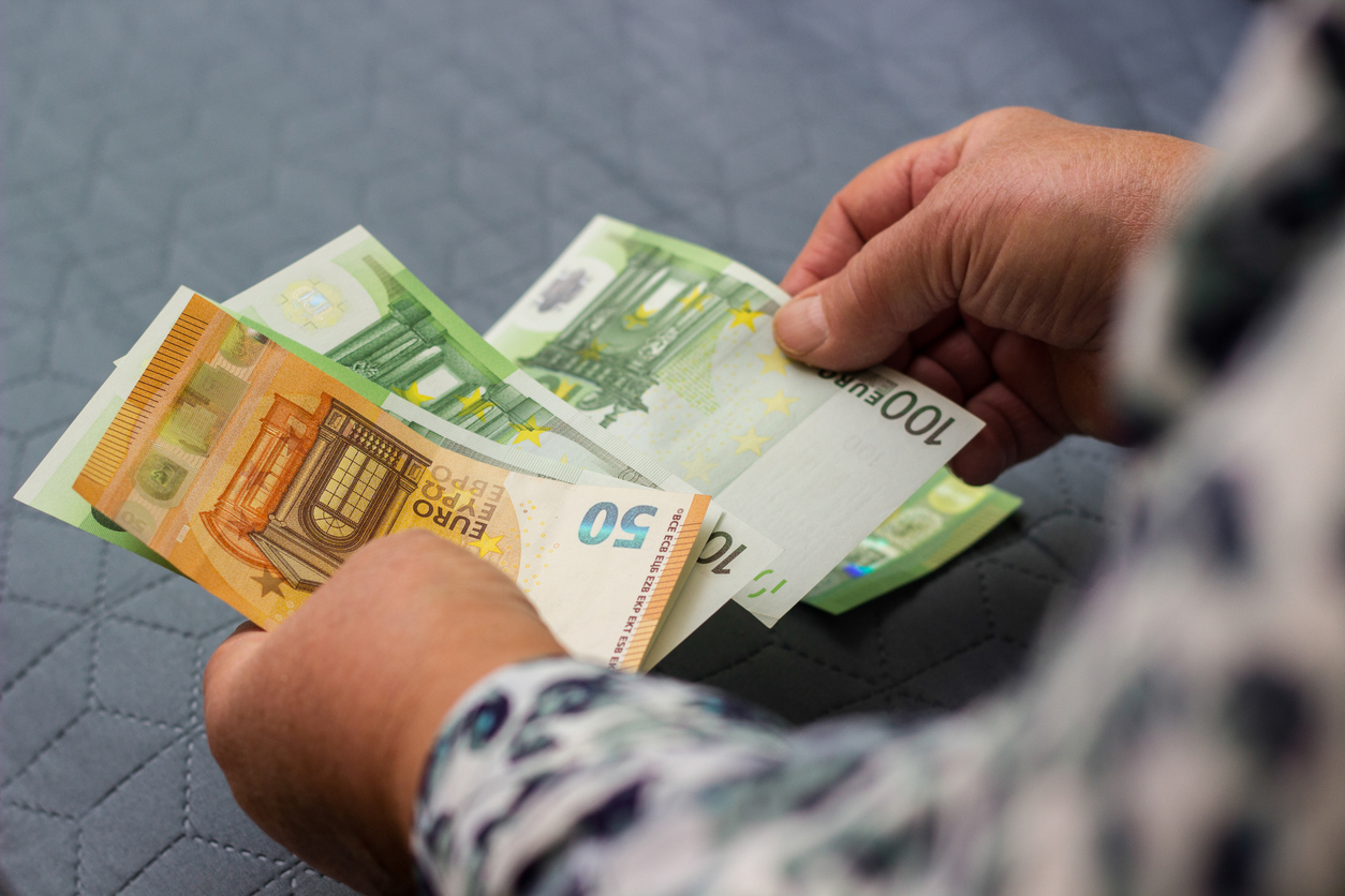 Senior woman hands counting money at home