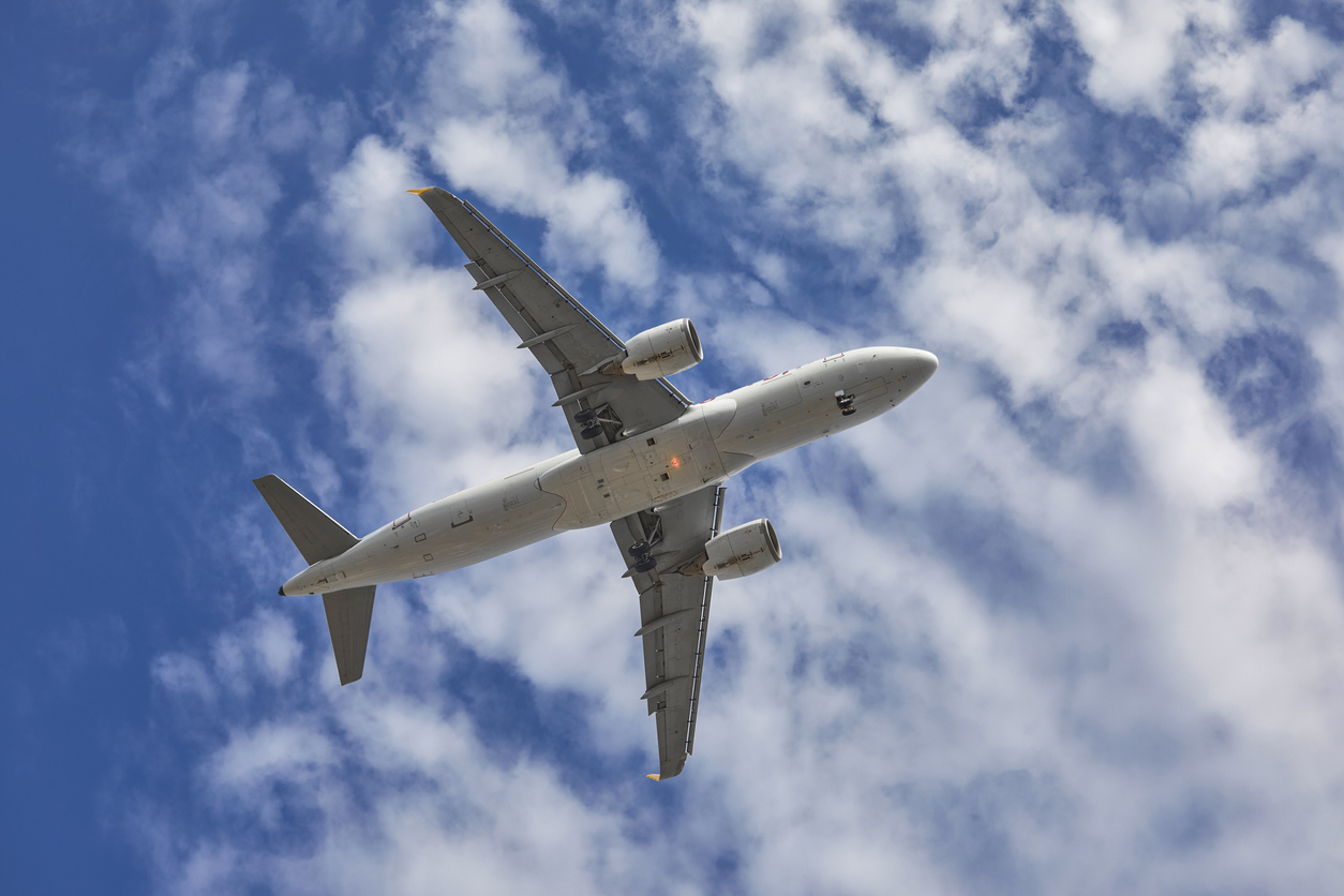 aircraft flying over the camera with landing gears down and ready to land