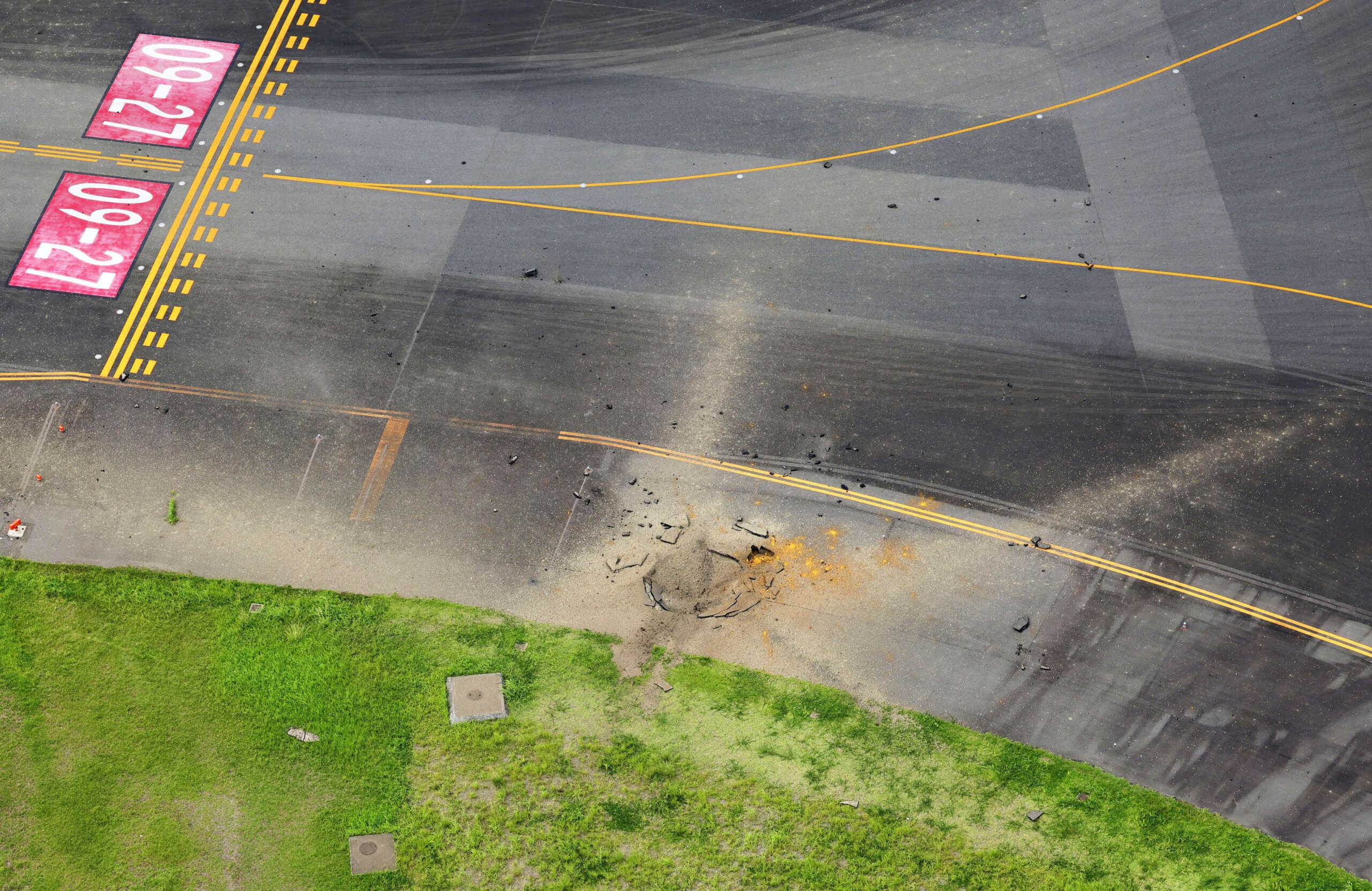 An aerial view taken from a helicopter shows a crater from an explosion after a likely WW2-era bomb exploded, on a taxiway at Miyazaki Airport in Miyazaki, southwestern Japan October 2, 2024, in this photo taken by Kyodo. Mandatory credit Kyodo via REUTERS ATTENTION EDITORS - THIS IMAGE WAS P,ROVIDED BY A THIRD PARTY. MANDATORY CREDIT. JAPAN OUT. NO COMMERCIAL OR EDITORIAL SALES IN JAPAN