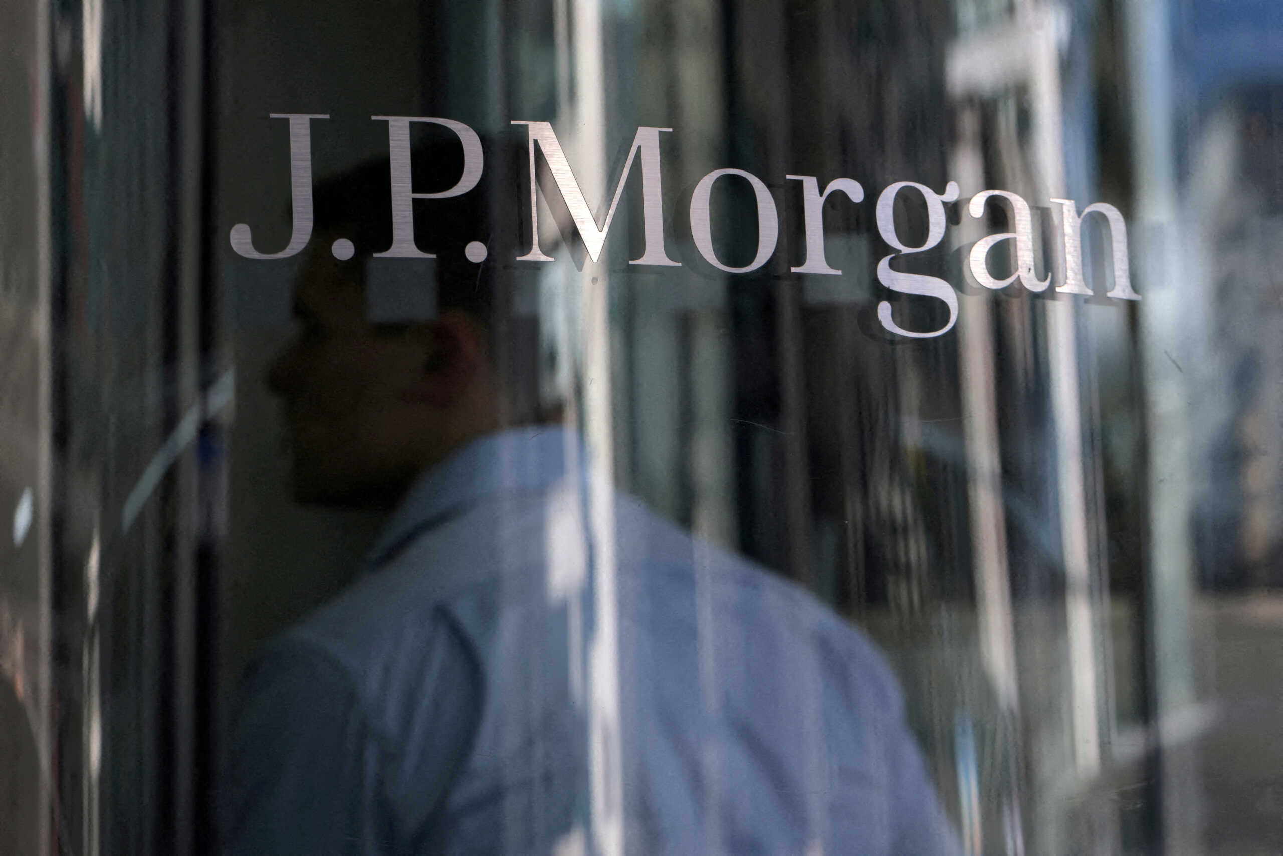 FILE PHOTO: A person enters the JPMorgan Chase & Co. New York headquarters in Manhattan, New York City, U.S., June 30, 2022. REUTERS