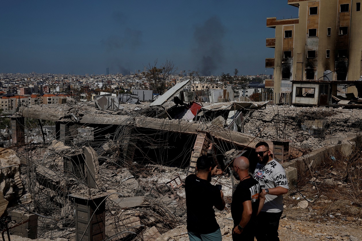 FILE PHOTO: People stand amid damage caused by Israeli airstrikes, as smoke rises over Beirut southern suburbs, amid ongoing hostilities between Hezbollah and Israeli forces, in the Choueifat district, in Beirut, Lebanon, October 3, 2024. REUTERS