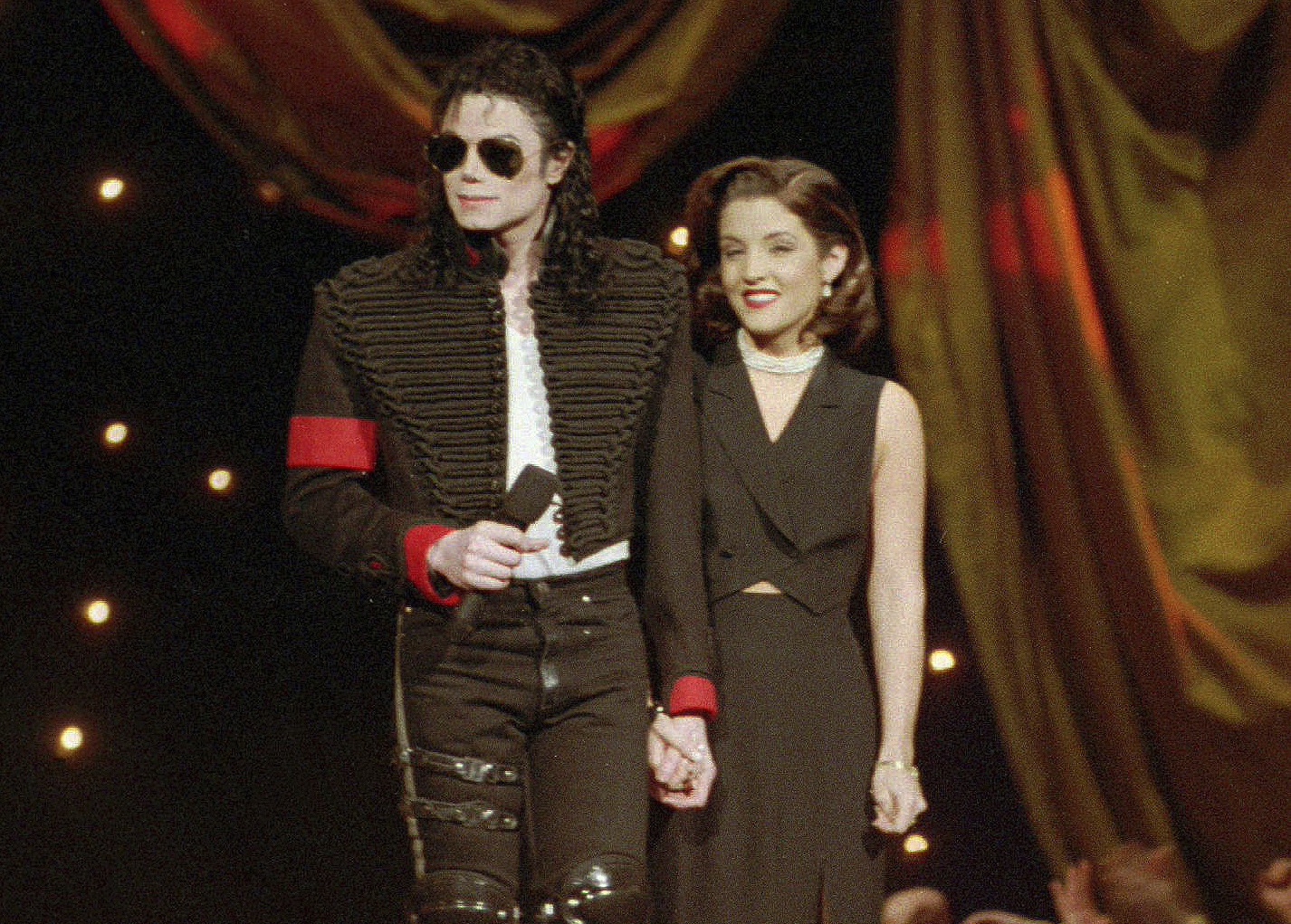 FILE - Michael Jackson and Lisa Marie Presley-Jackson acknowledge applause from the audience after coming out onstage to open the 11th annual MTV Video Music Awards at New York's Radio City Music Hall, Sept. 8, 1994. Presley, singer and only child of Elvis, died Thursday, Jan. 12, 2023, after a hospitalization, according to her mother, Priscilla Presley. She was 54. (AP Photo