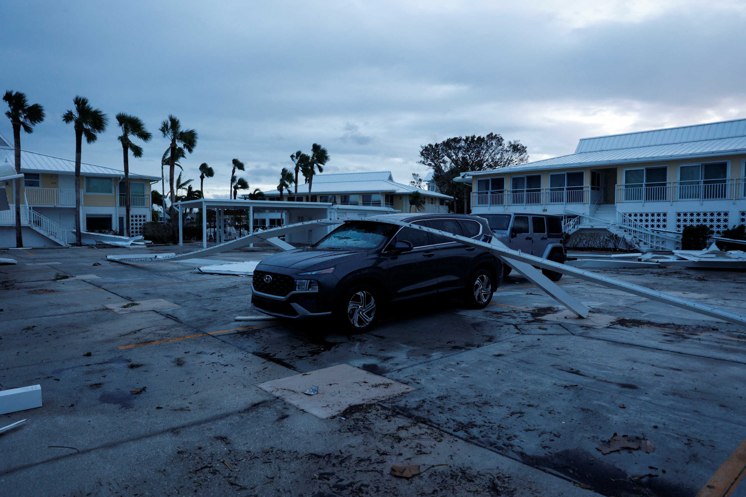 Broken structures lie on top of a car after Hurricane Milton made landfall, in Venice, Florida, U.S., October 10, 2024. REUTERS