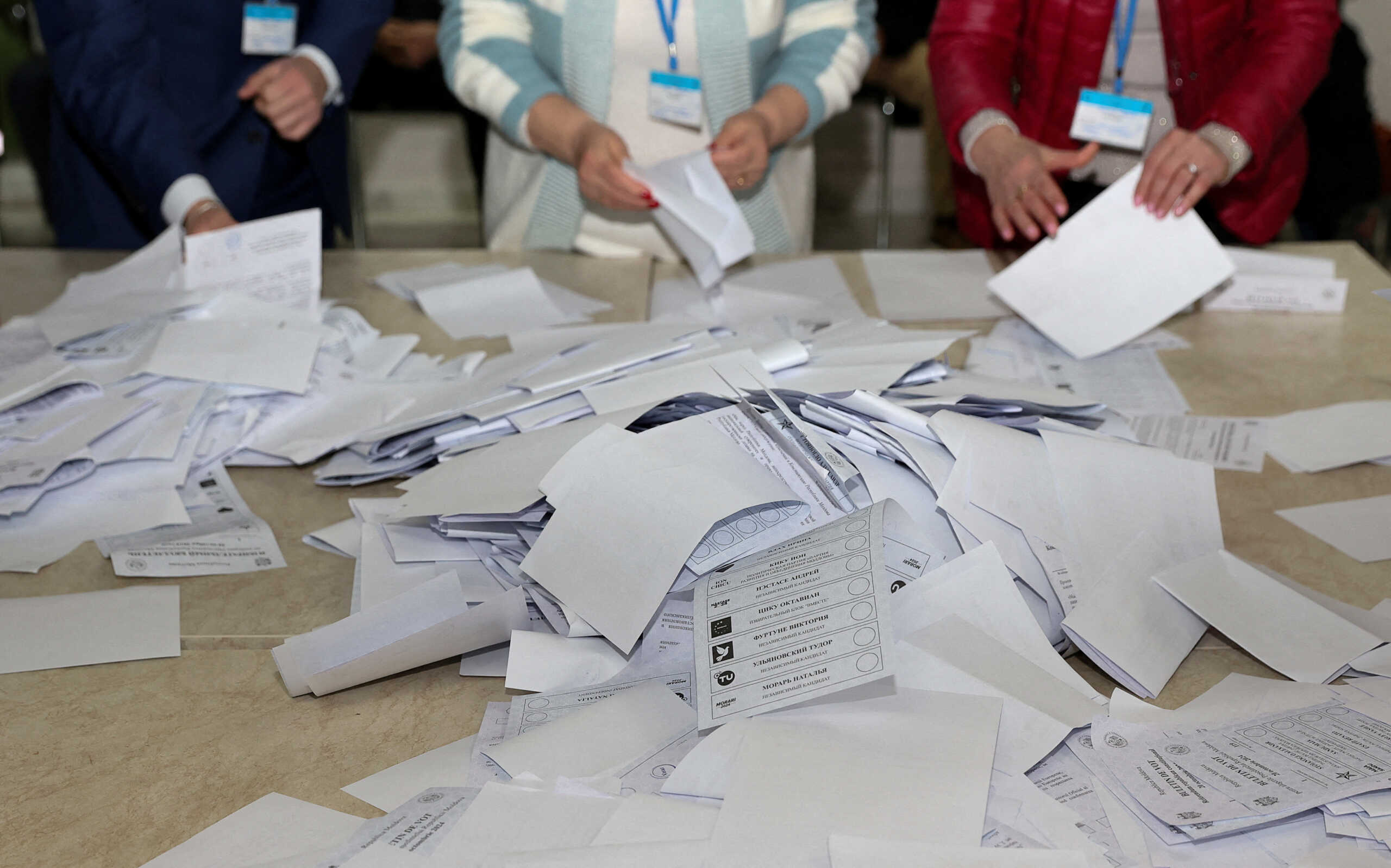 Members of an electoral commission count votes after polling stations closed in the course of Moldova's presidential election and a referendum on joining the European Union, in Chisinau, Moldova October 20, 2024. REUTERS