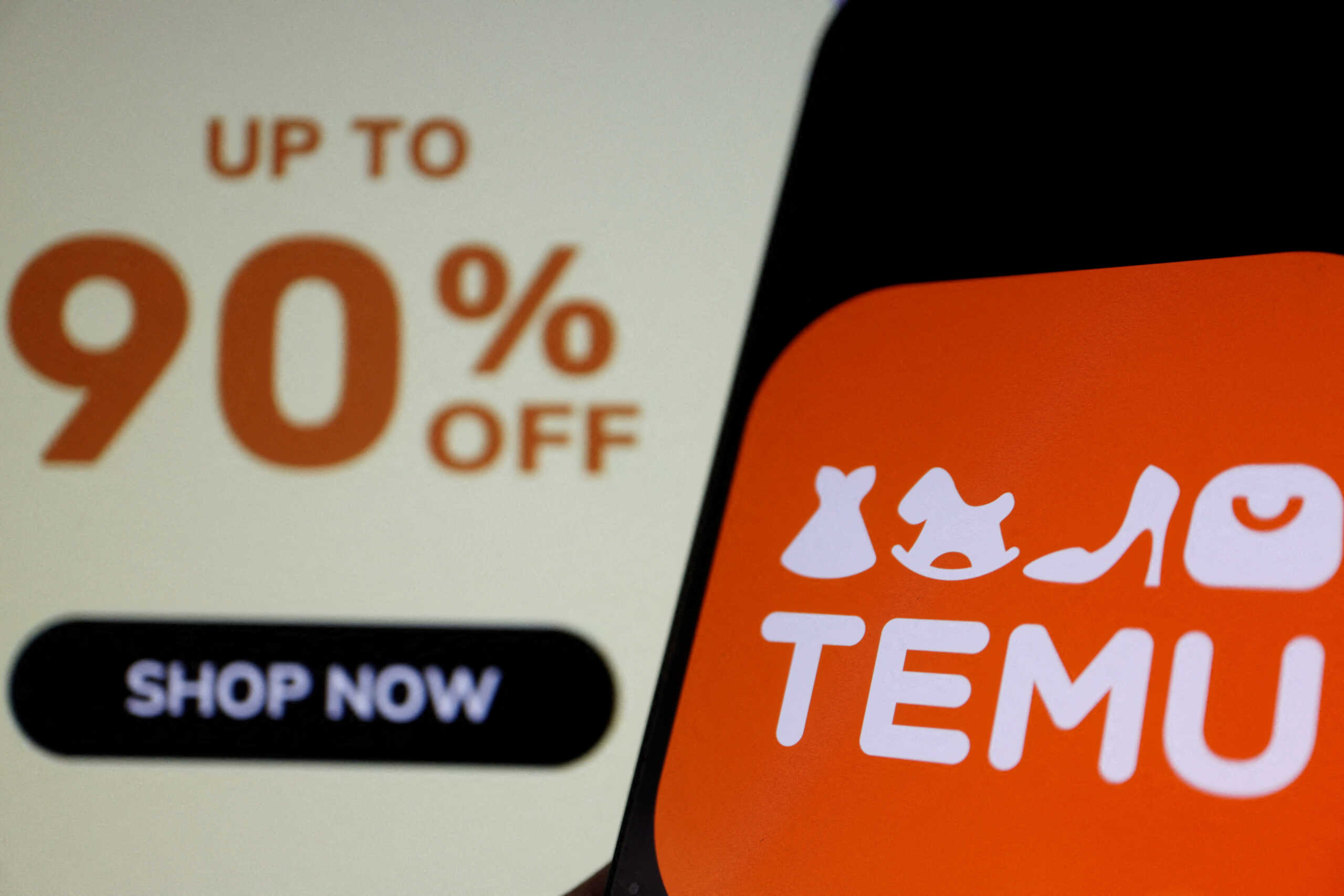 FILE PHOTO: The logo of Temu, an e-commerce platform owned by PDD Holdings, is seen on a mobile phone displayed in front of its website, in this illustration picture taken April 26, 2023. REUTERS