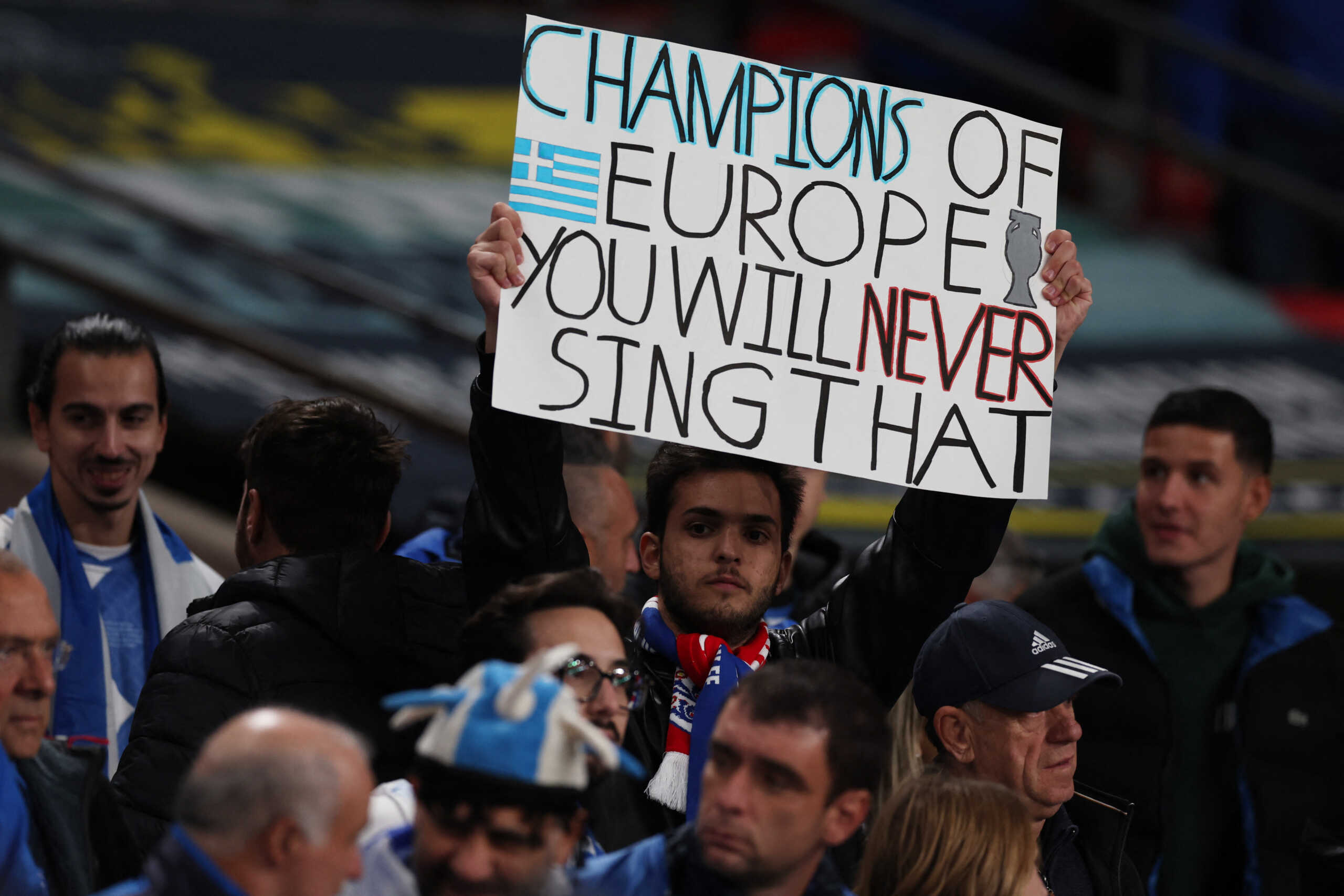 Soccer Football - UEFA Nations League - Group B2 - England v Greece - Wembley Stadium, London, Britain - October 10, 2024 Greece fan holds up a sign inside the stadium before the match Action Images via Reuters