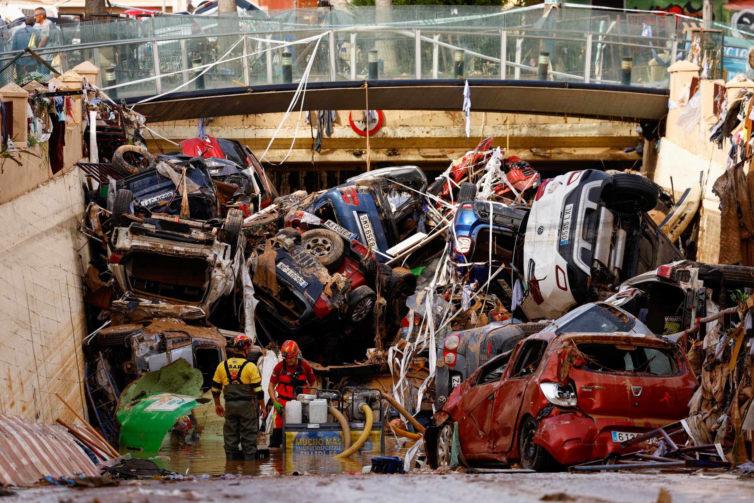 Firefighters pump out the floodwater out of a tunnel where vehicles are piled up, after heavy rains in Alfafar, in Valencia, Spain, November 1, 2024. REUTERS