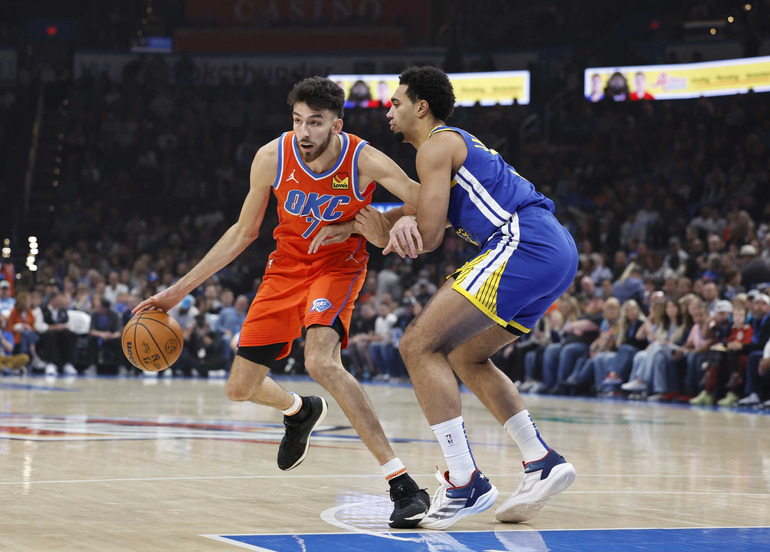 Nov 10, 2024; Oklahoma City, Oklahoma, USA; Oklahoma City Thunder forward Chet Holmgren (7) moves the ball around Golden State Warriors forward Trayce Jackson-Davis (32) during the first quarter at Paycom Center. Mandatory Credit: Alonzo Adams-Imagn Images