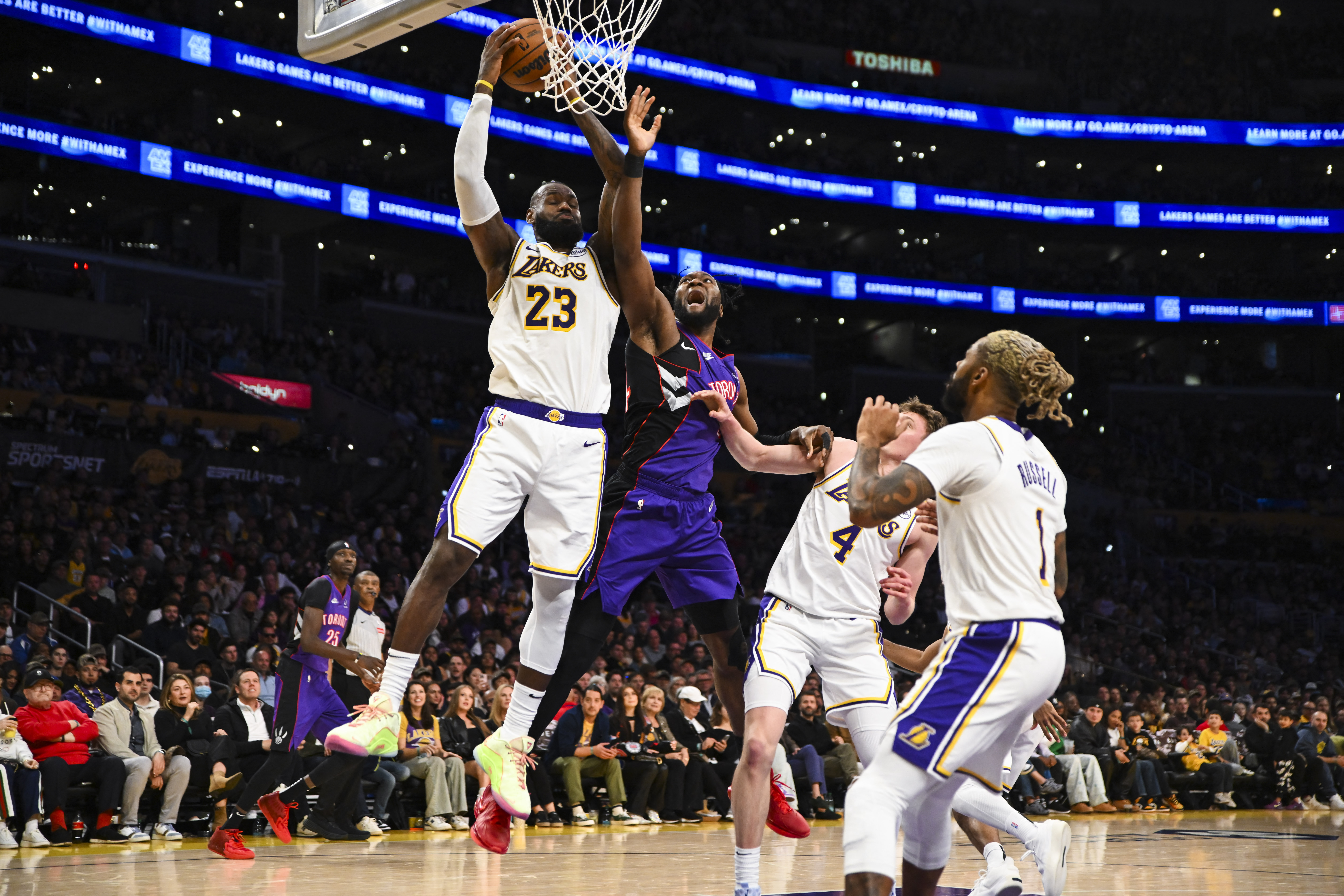 Nov 10, 2024; Los Angeles, California, USA; Los Angeles Lakers forward LeBron James (23) grabs the rebound against Toronto Raptors forward Bruno Fernando (24) during the second half at Crypto.com Arena. Mandatory Credit: Jonathan Hui-Imagn Images