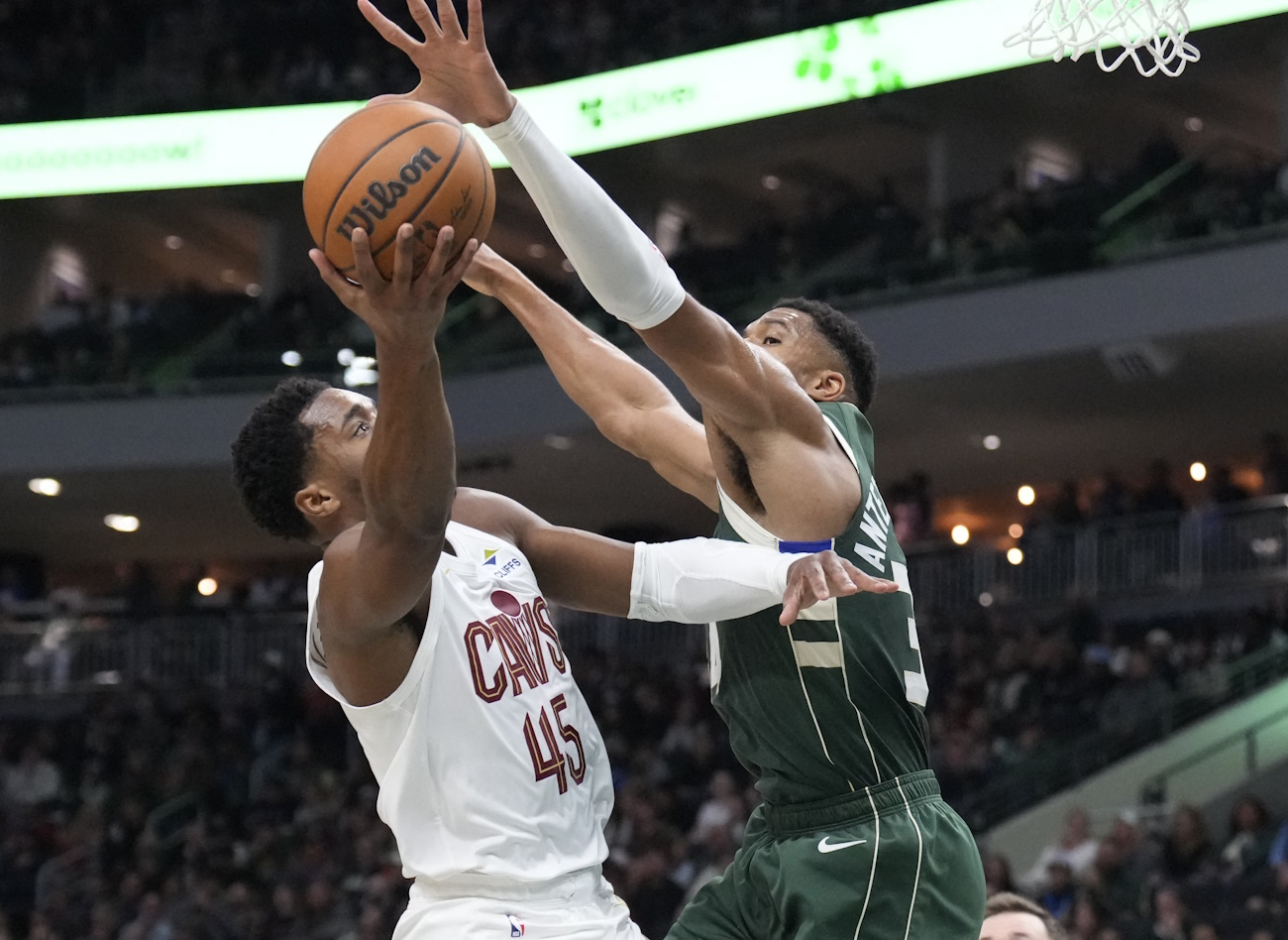 Nov 2, 2024; Milwaukee, Wisconsin, USA; Cleveland Cavaliers guard Donovan Mitchell (45) drives to the basket against Milwaukee Bucks forward Giannis Antetokounmpo (34) in the first half at Fiserv Forum. Mandatory Credit: Michael McLoone-Imagn Images