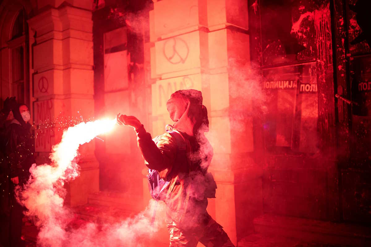 A demonstrator throws a flare during a protest over an accident at a railway station in the Serbian city of Novi Sad, for which they blame negligence and corruption by the authorities, in front of the city hall of Novi Sad, Serbia November 5, 2024. REUTERS