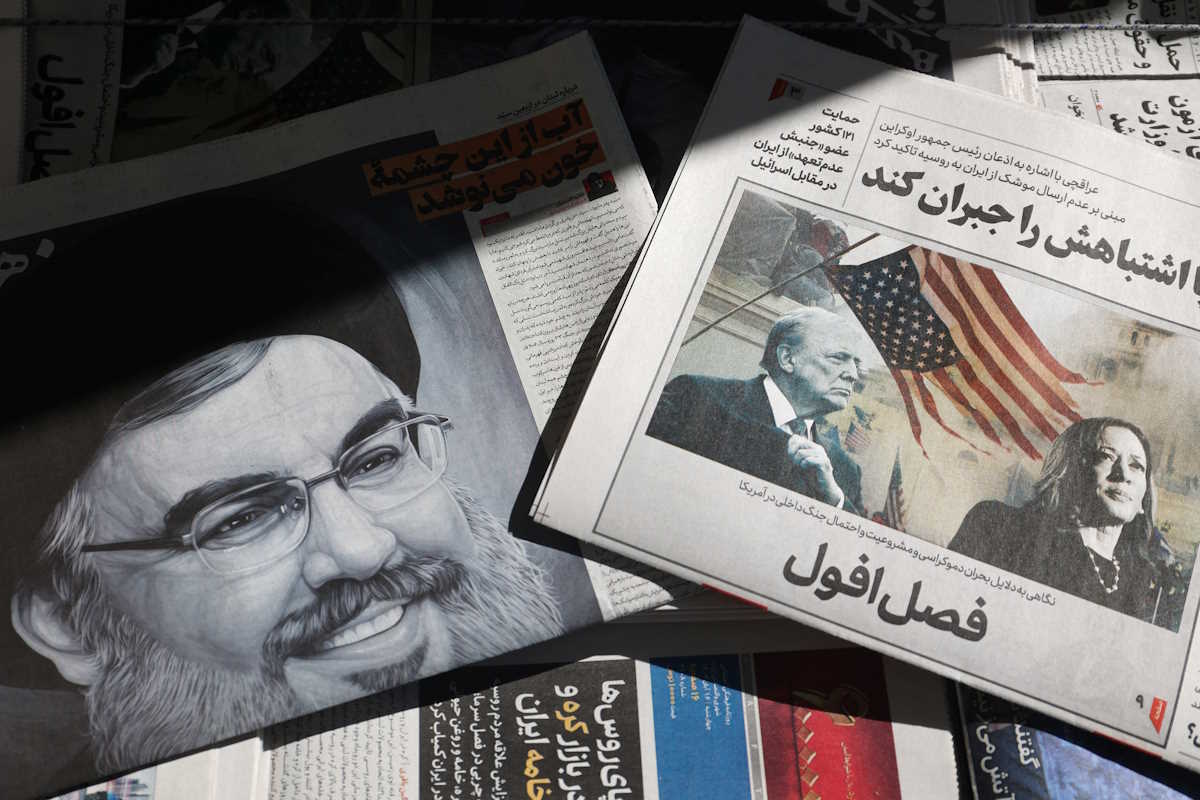 A newspaper with a picture of Republican presidential nominee and former U.S. President Donald Trump and Democratic presidential nominee U.S. Vice President Kamala Harris is seen next to a newspaper with a picture of late Lebanon's Hezbollah leader Sayyed Hassan Nasrallah, in Tehran, Iran November 6, 2024. Majid Asgaripour