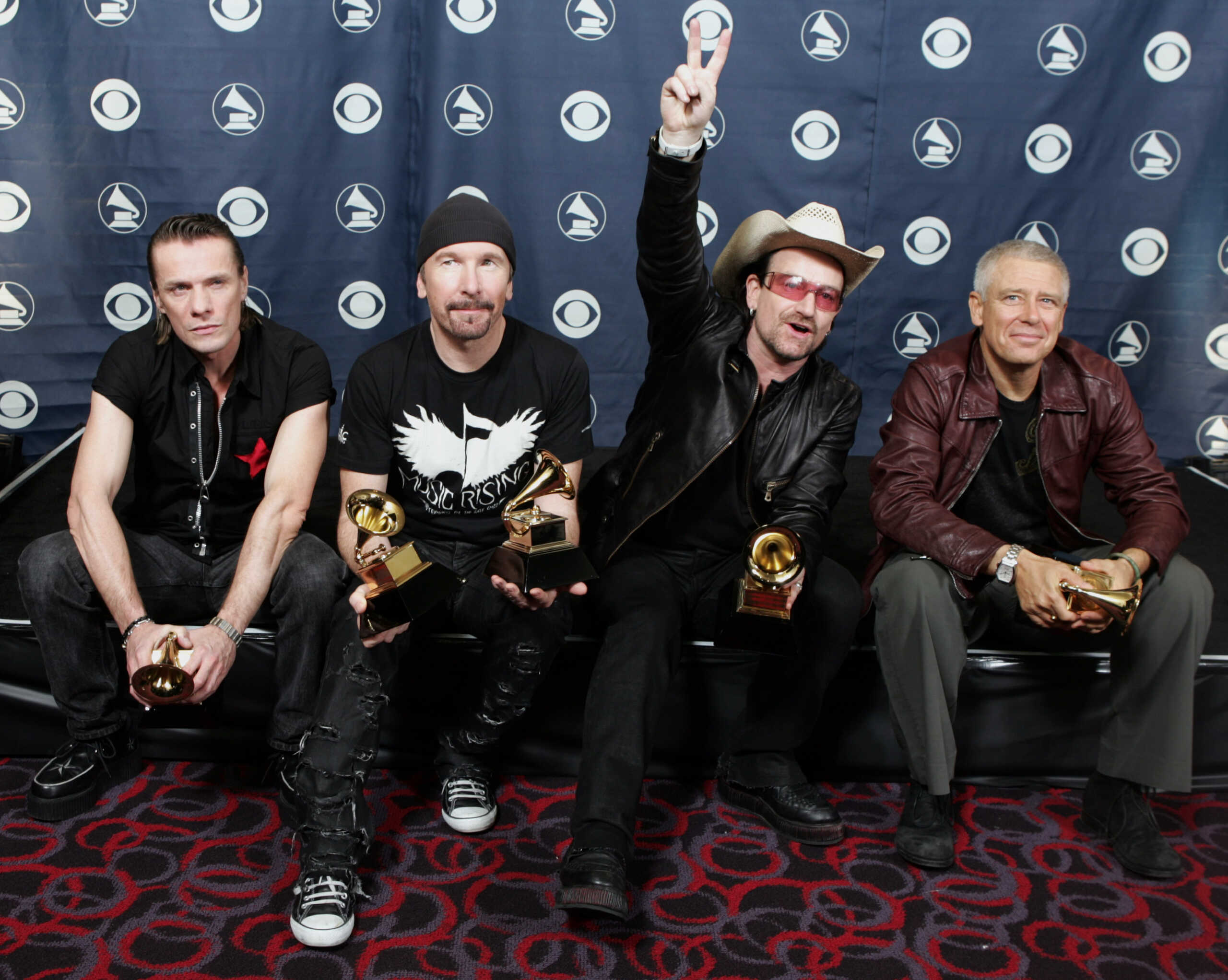 The band U2, from left to right, Larry Mullen, The Edge, Bono, and Adam Clayton appear backstage with Grammy's for song of the year, album of the year, best rock song, best rock performance by a duo or group with vocal, and best rock album, at the 48th Annual Grammy Awards on Wednesday, Feb. 8, 2006, in Los Angeles. (AP Photo