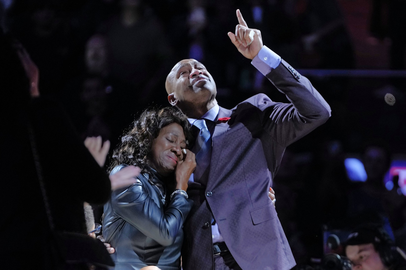 Nov 2, 2024; Toronto, Ontario, CAN; Former Toronto Raptors player Vince Carter points to the banner depicting the reitement of his jersey as he holds his mother Michelle during a ceremony at halftime of a game against the Sacramento Kings at Scotiabank Arena. Mandatory Credit: John E. Sokolowski-Imagn Images