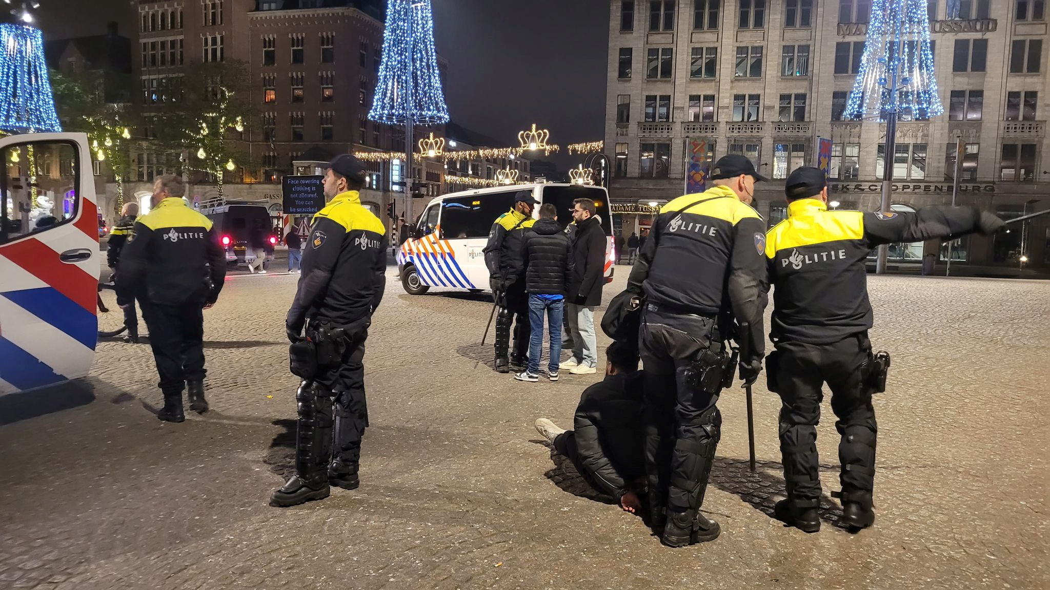 Policemen detain a person after youth clashed with Israeli football supporters, in Amsterdam, Netherlands, November 8, 2024. Mizzle Media