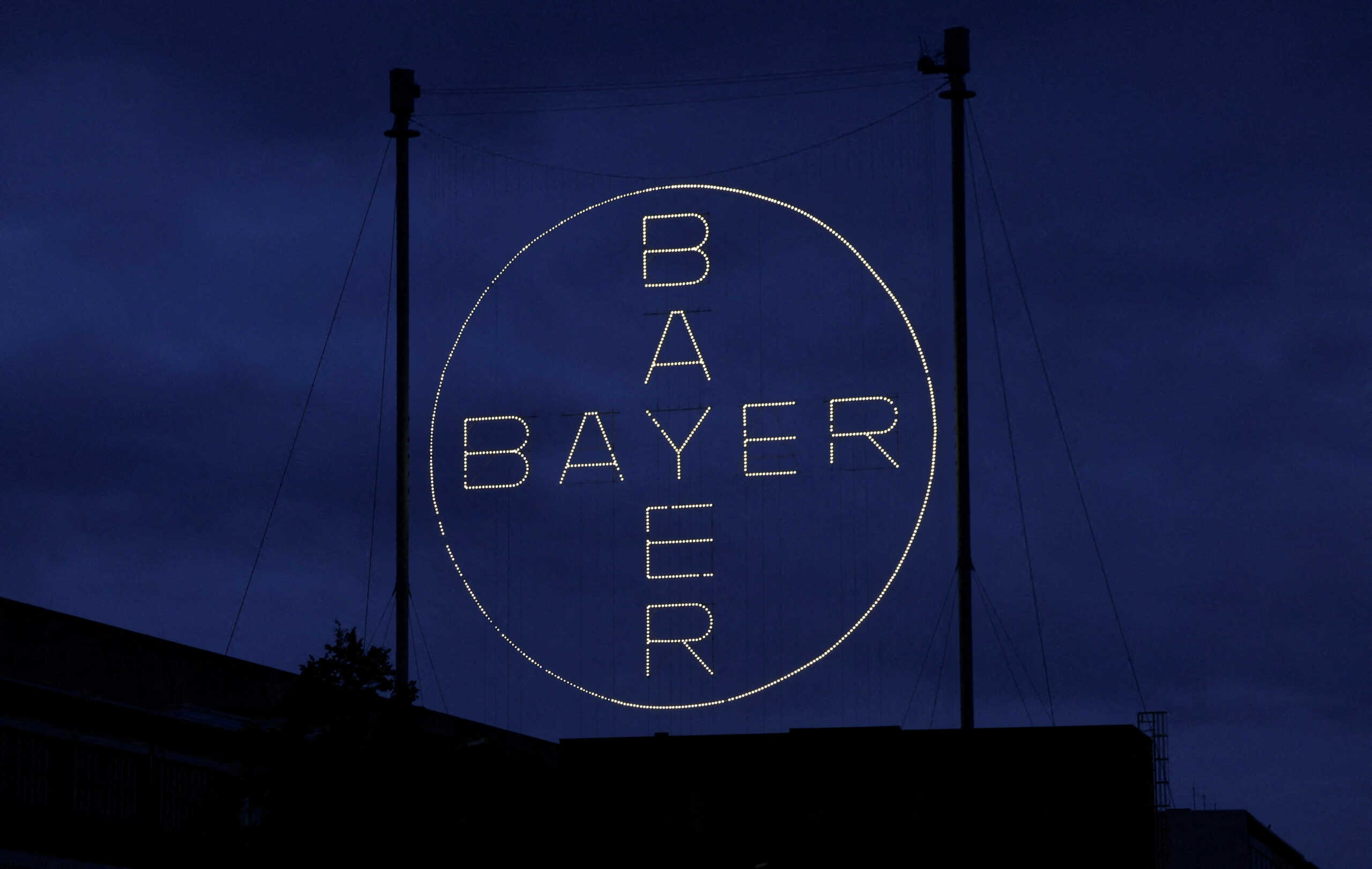 FILE PHOTO: The 120 metres high Bayer Cross, logo of German pharmaceutical and chemical maker Bayer AG, consisting of 1710 LED glass bulbs is seen outside the industrial park "Chempark" of the chemical industry in Leverkusen, Germany, September 23, 2023. REUTERS