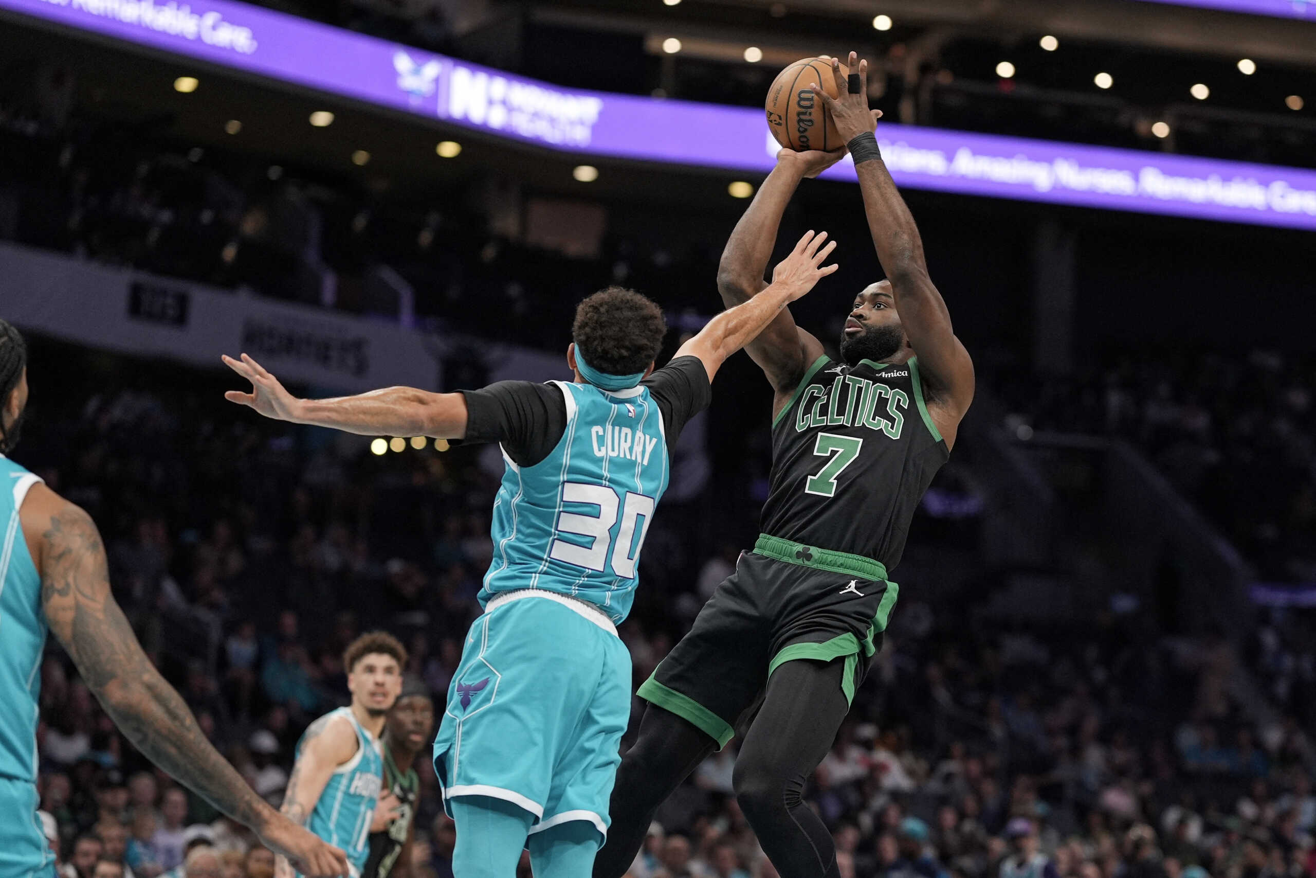 Nov 1, 2024; Charlotte, North Carolina, USA; Boston Celtics guard Jaylen Brown (7) shoots over Charlotte Hornets guard Seth Curry (30) during the first quarter at the Spectrum Center. Mandatory Credit: Jim Dedmon-Imagn Images