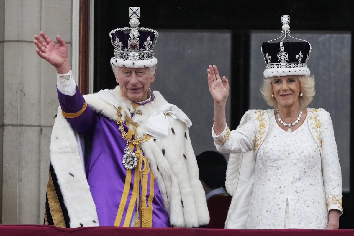 Britain's King Charles III and Queen Camilla wave to the crowds from the balcony of Buckingham Palace after the coronation ceremony in London, Saturday, May 6, 2023. (AP Photo