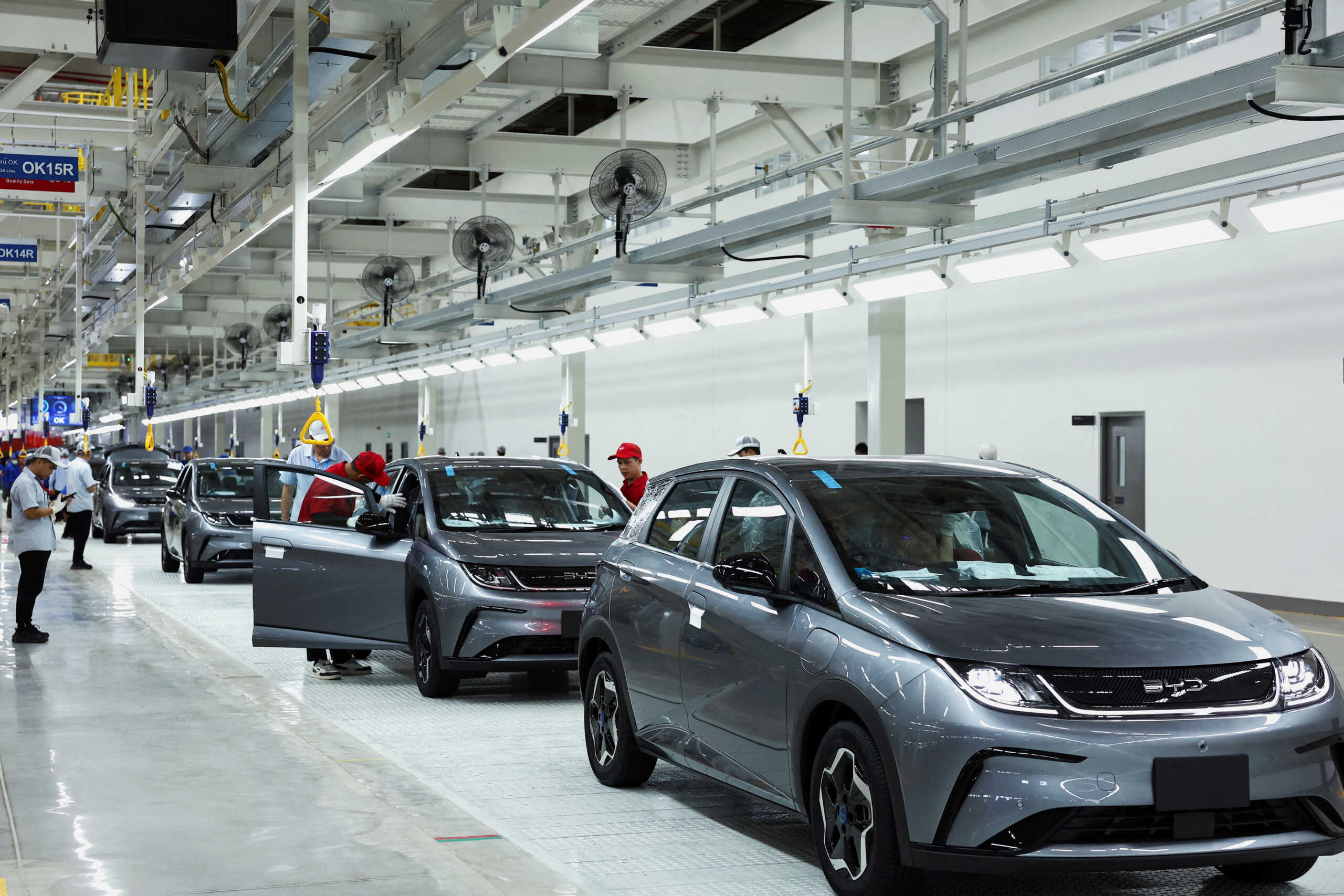 FILE PHOTO: Workers check the EV cars inside BYD's first electric vehicle (EV) factory in Southeast Asia, a fast-growing regional EV market where it has become the dominant player, in Rayong, Thailand, July 4, 2024. REUTERS