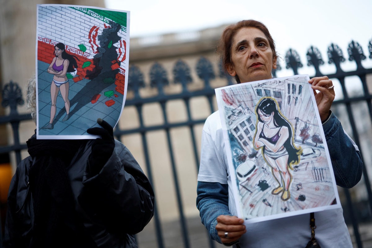 People hold placards in support of an Iranian female student, named as Ahoo Daryaei on social media, seen in her underwear at a Tehran university in protest against country's strict Islamic dress code, and all Iranian women who fight for freedom, during a rally in front of the Pantheon in Paris, France, November 5, 2024.  REUTERS