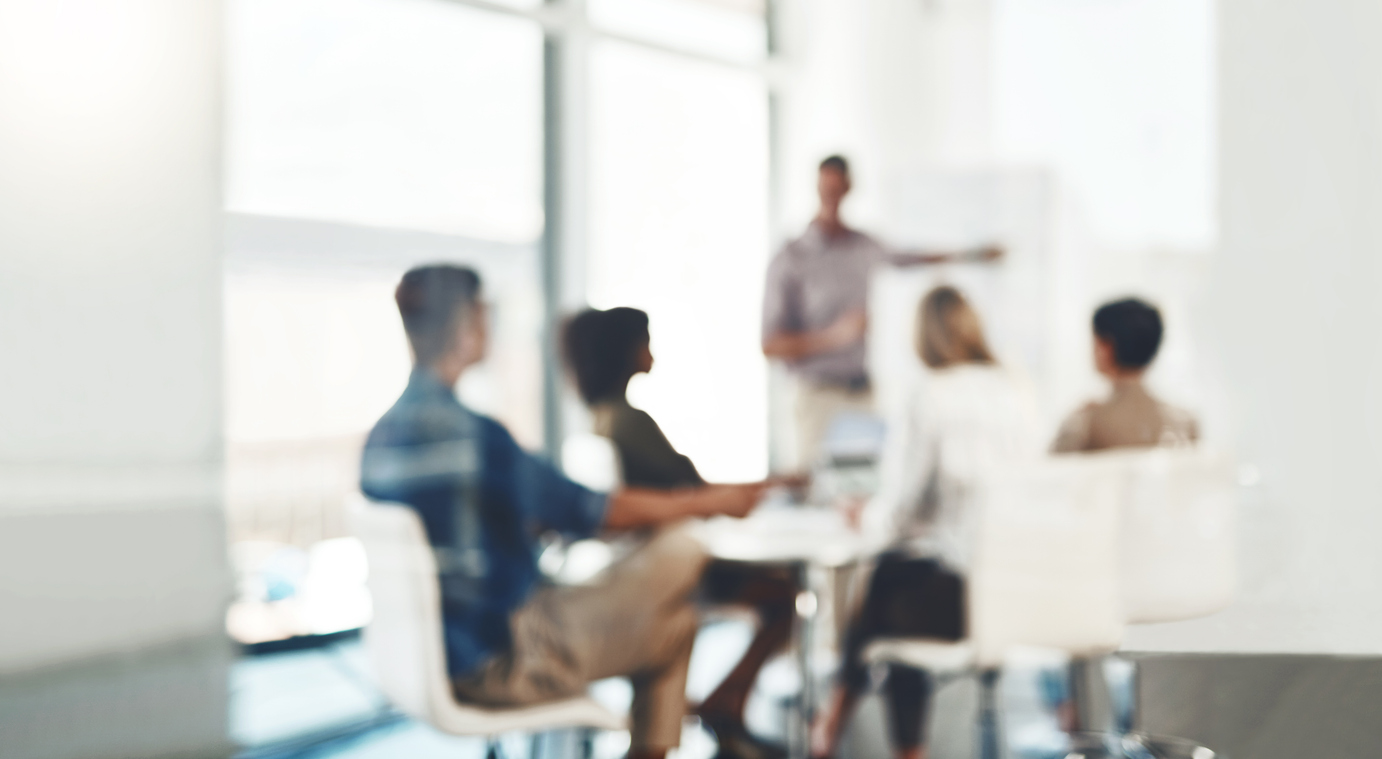 Defocused shot of a group of businesspeople having a meeting in an office