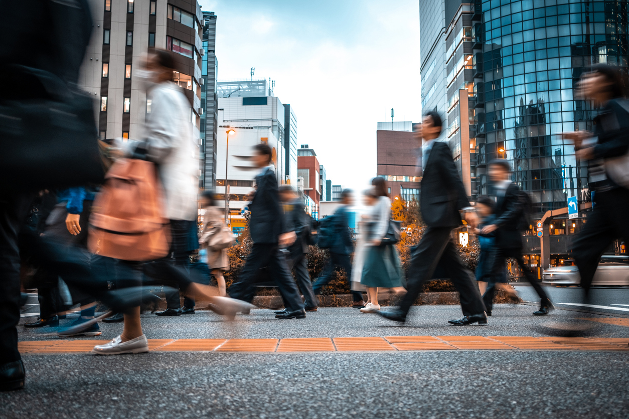 Crowd of business people on their way from work. They are unrecognisable. Long exposure shot.