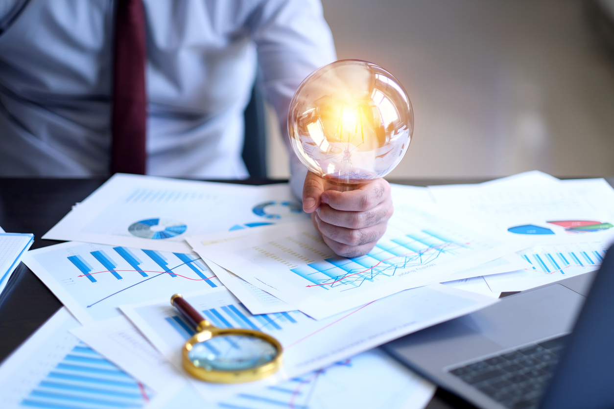 Businessman holding a big light bulb