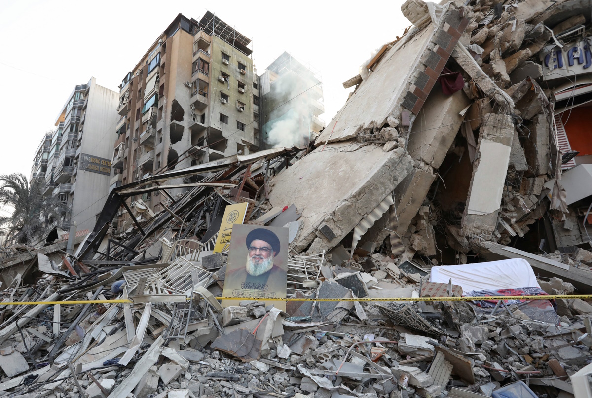 A poster of late Hezbollah leader Sayyed Hassan Nasrallah is placed on the rubble of a damaged building, in the aftermath of Israeli strikes on Beirut's southern suburbs, amid the ongoing hostilities between Hezbollah and Israeli forces, Lebanon, November 14, 2024. REUTERS