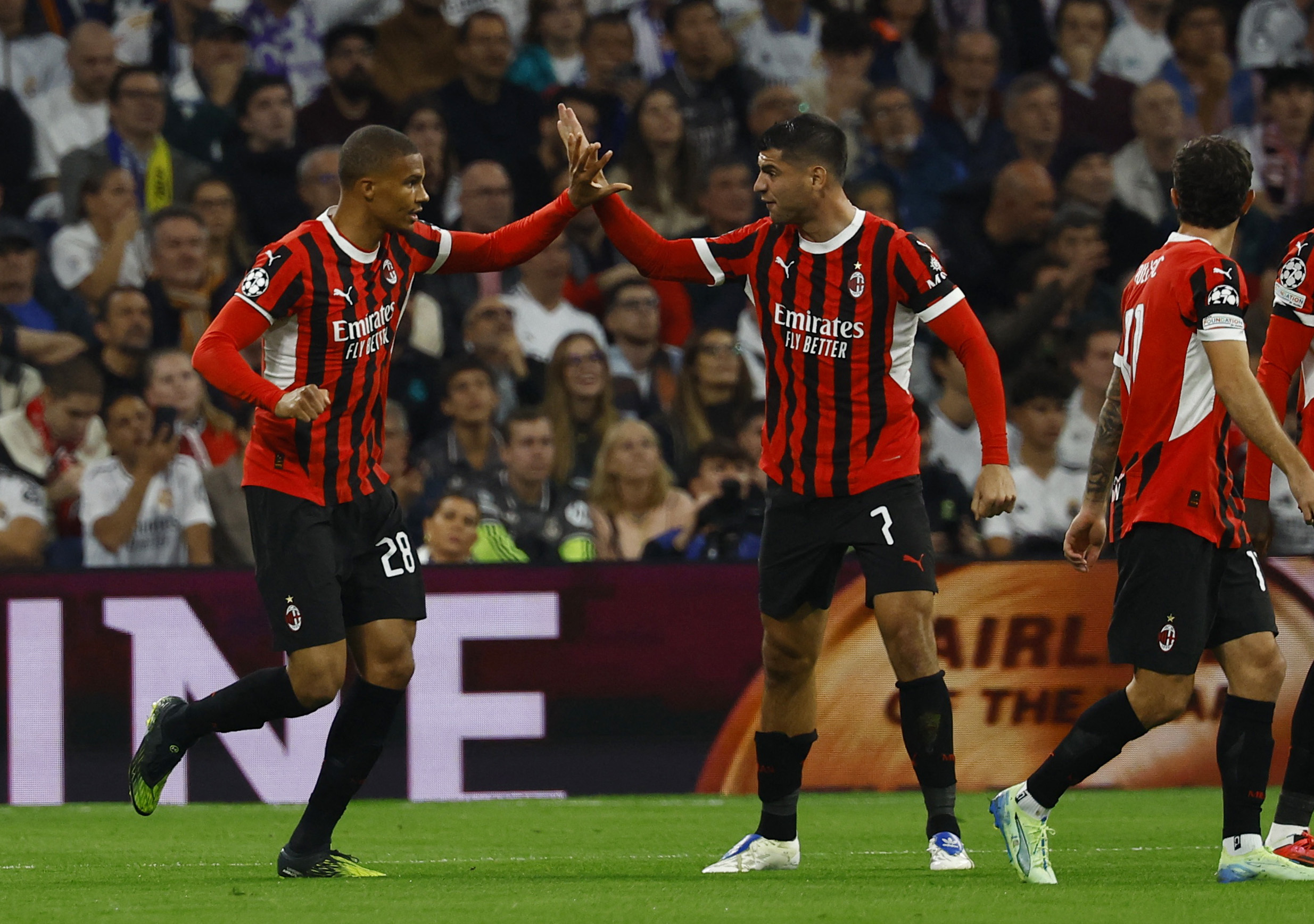 Soccer Football - Champions League - Real Madrid v AC Milan - Santiago Bernabeu, Madrid, Spain - November 5, 2024 AC Milan's Malick Thiaw celebrates scoring their first goal with Alvaro Morata REUTERS