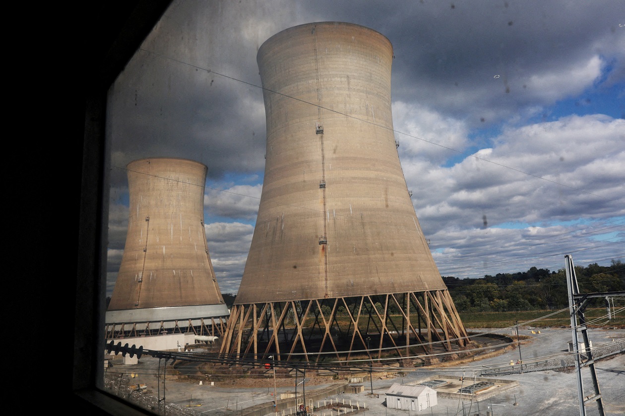 FILE PHOTO: Cooling towers are seen through a window at the Three Mile Island Nuclear power plant, during a tour by Constellation Energy which has ordered a main power transformer for the nuclear reactor it is trying to reopen, in Middletown, Pennsylvania, U.S., October 16, 2024. REUTERS