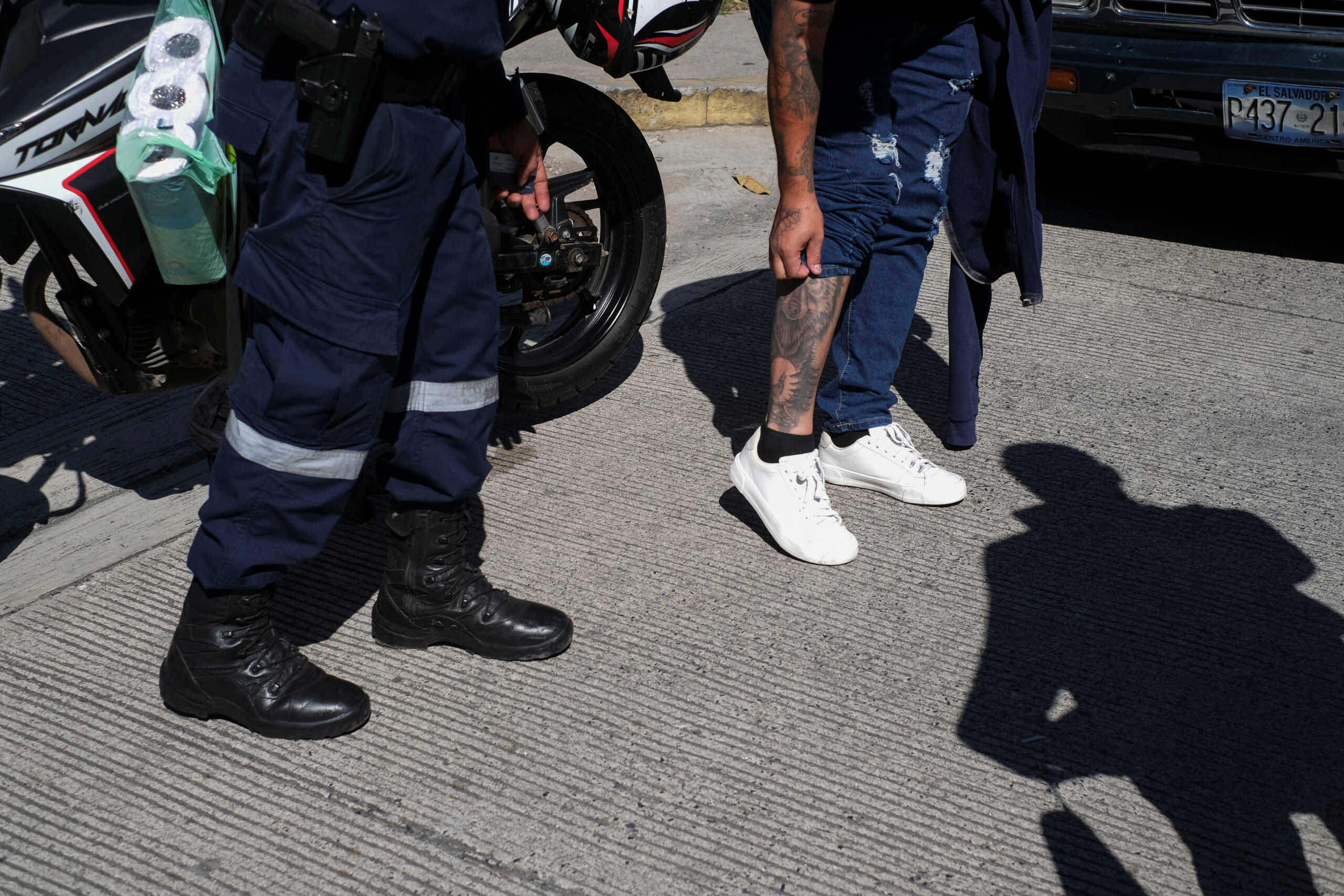 Police officers inspect a man's tattoos at a checkpoint after El Salvador's President Nayib Bukele announced the deployment of security forces to search gang remnants, at the 10 de Octubre neighborhood in San Marcos, El Salvador October 28, 2024. REUTERS