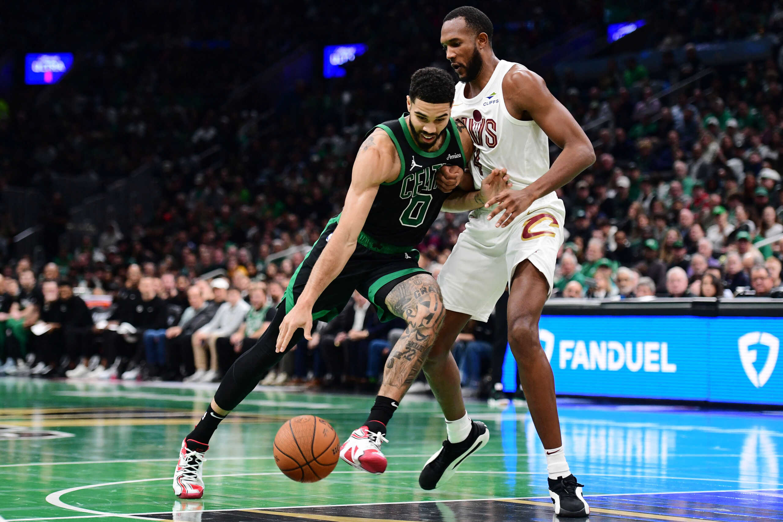 Nov 19, 2024; Boston, Massachusetts, USA; Boston Celtics forward Jayson Tatum (0) drives to the basket while Cleveland Cavaliers forward Evan Mobley (4) defends during the first half at TD Garden. Mandatory Credit: Bob DeChiara-Imagn Images