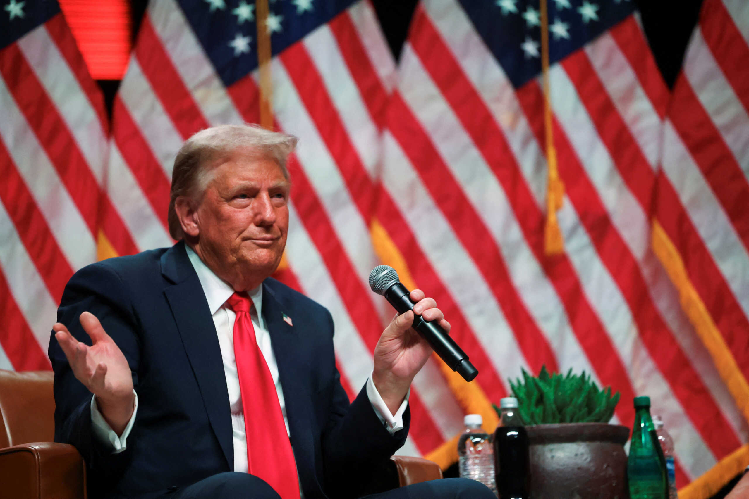 Republican presidential nominee and former U.S. President Donald Trump participates in a fireside chat with Tucker Carlson at 'Tucker Carlson Live on Tour' at Desert Diamond Arena, in Glendale, Arizona, U.S. October 31, 2024. REUTERS