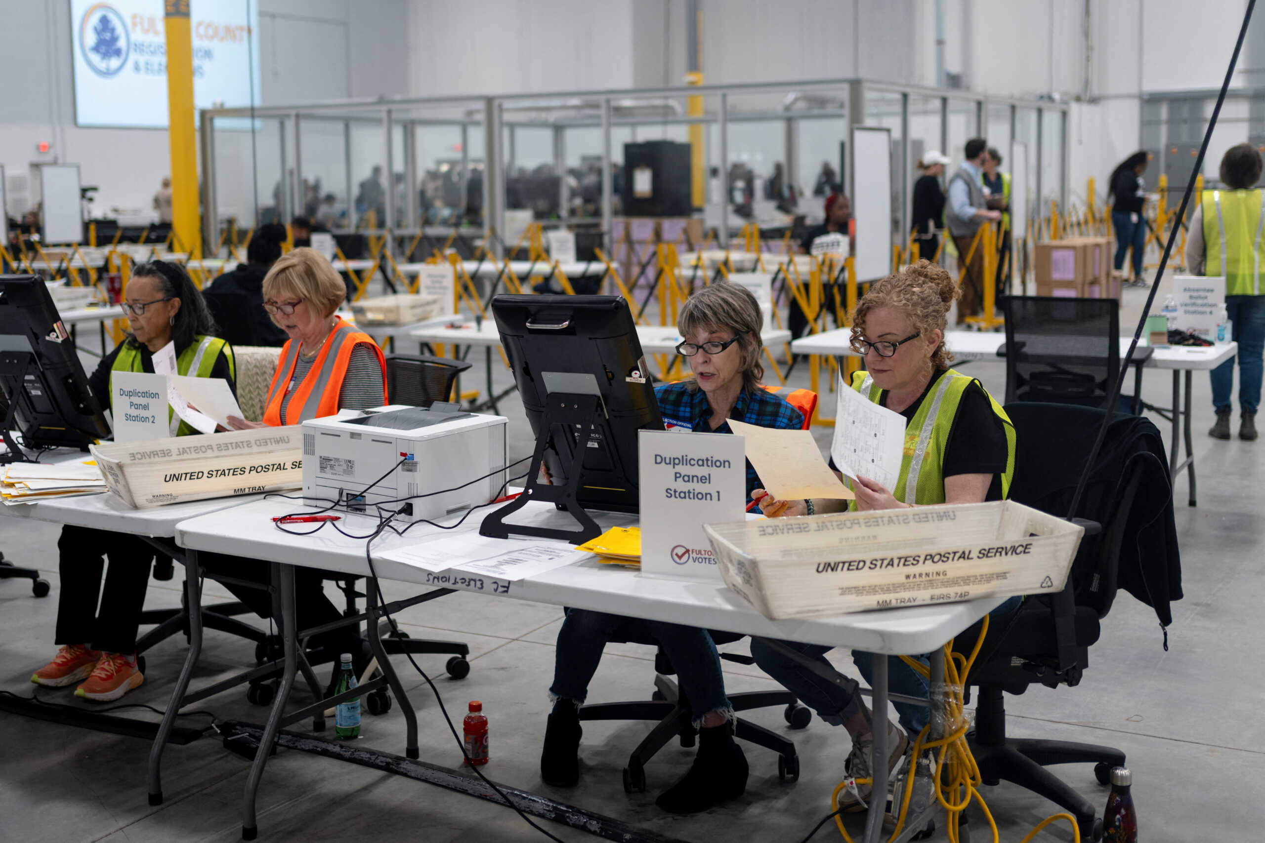 Fulton county workers process absentee ballots at Fulton County Operations Hub and Elections Center the day before the U.S. presidential election, in Atlanta, Georgia U.S., November 4, 2024. REUTERS