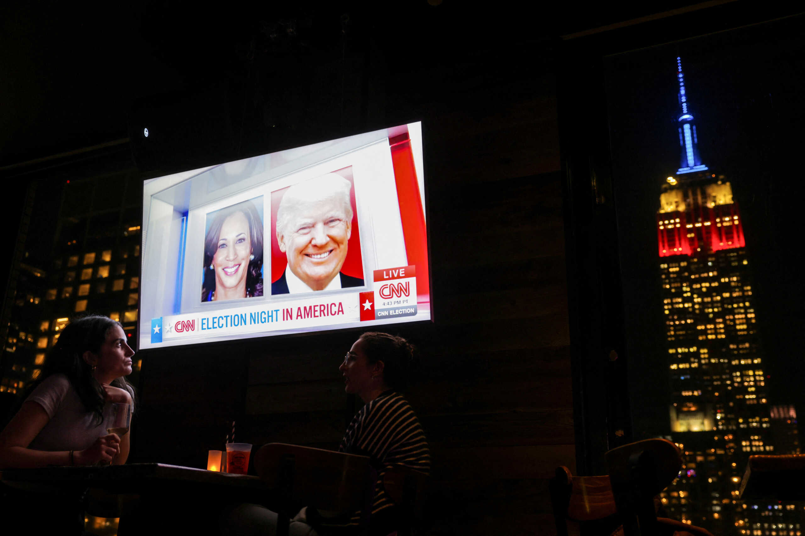 People attend a watch party at 230 Fifth Rooftop Bar, as the Empire State Building is seen in the background, in New York City, U.S., November 5, 2024. REUTERS