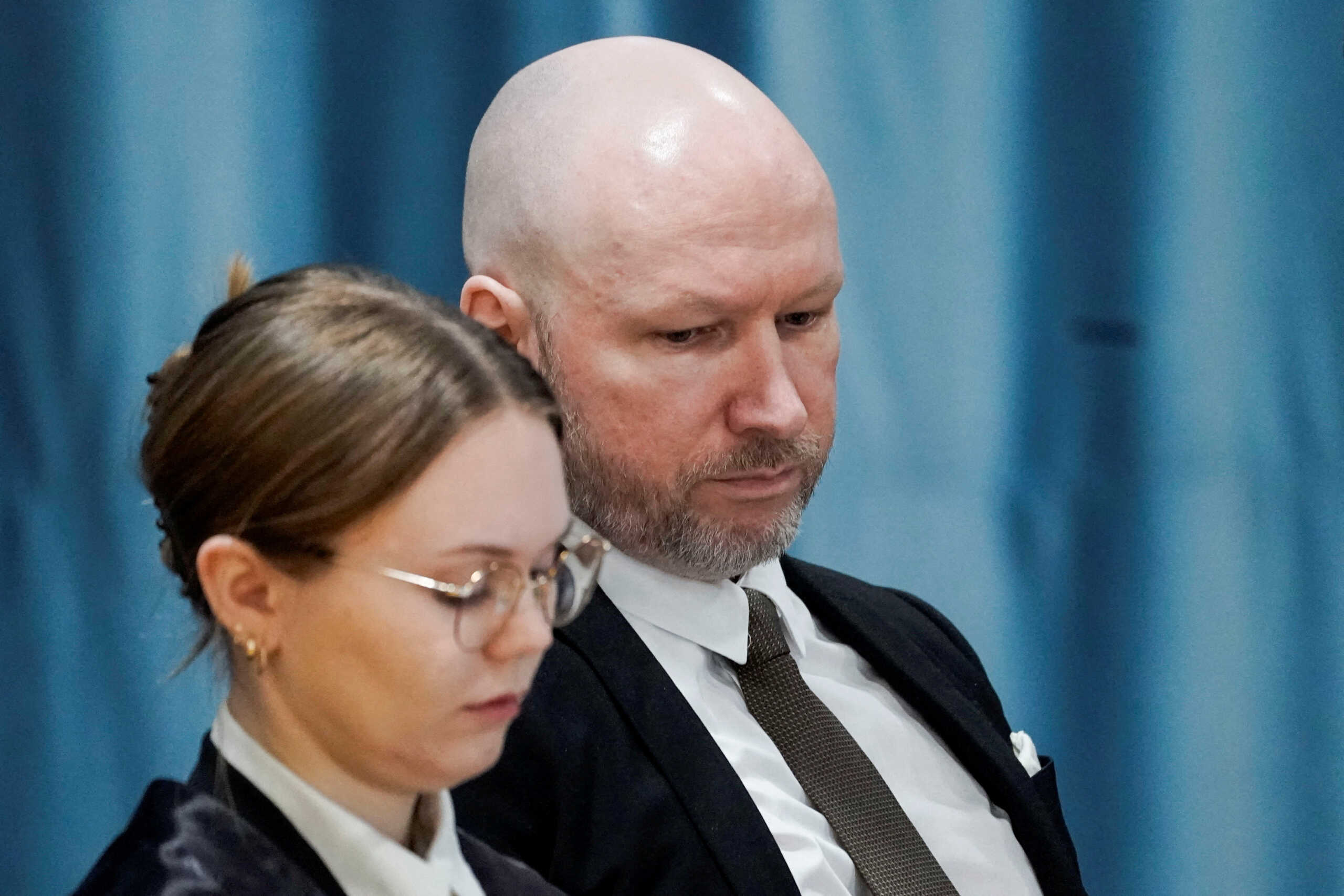 FILE PHOTO: Anders Behring Breivik and attorney Marte Lindholm attend a court hearing at Ringerike prison, in Tyristrand, Norway, January 8, 2024. Cornelius Poppe