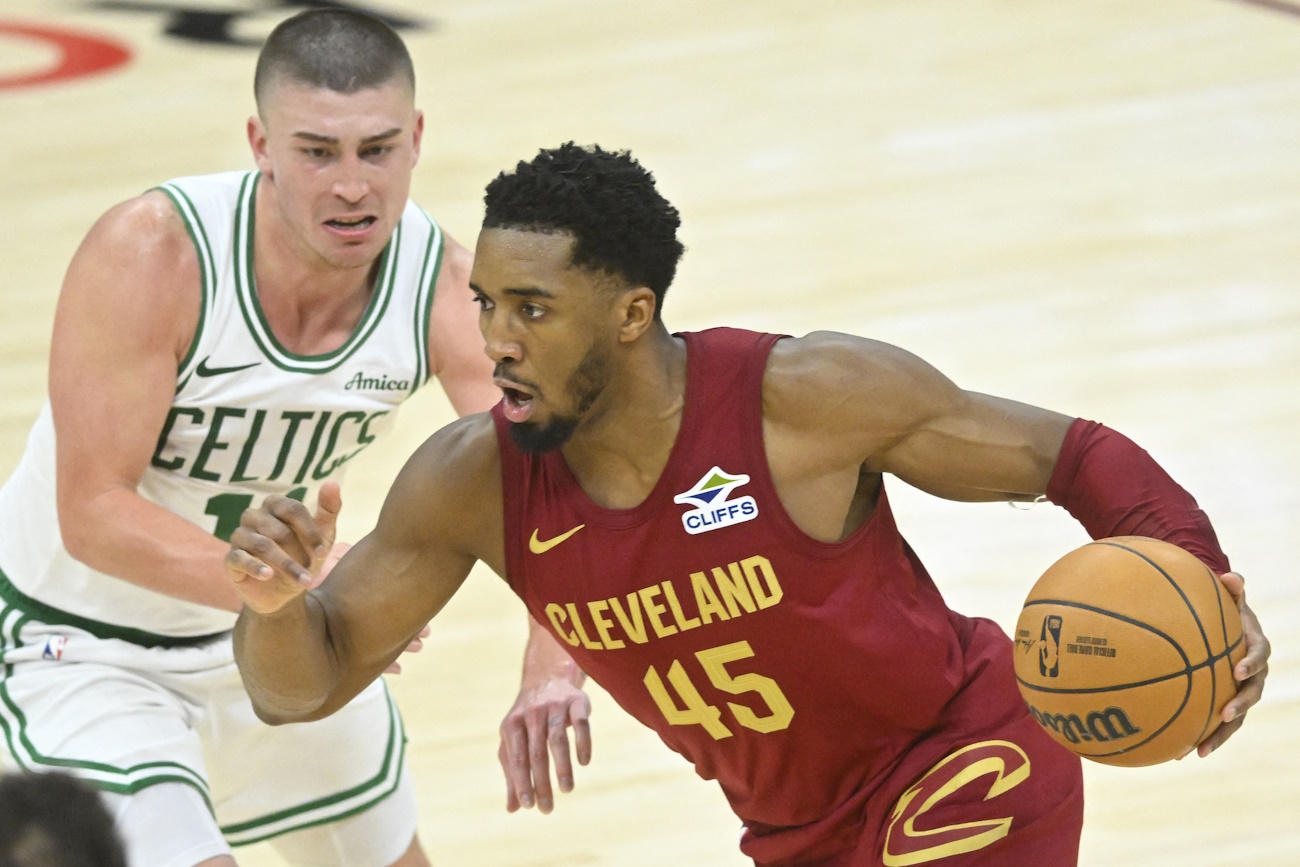 Dec 1, 2024; Cleveland, Ohio, USA; Cleveland Cavaliers guard Donovan Mitchell (45) dribbles beside Boston Celtics guard Payton Pritchard (11) in the third quarter at Rocket Mortgage FieldHouse. Mandatory Credit: David Richard-Imagn Images