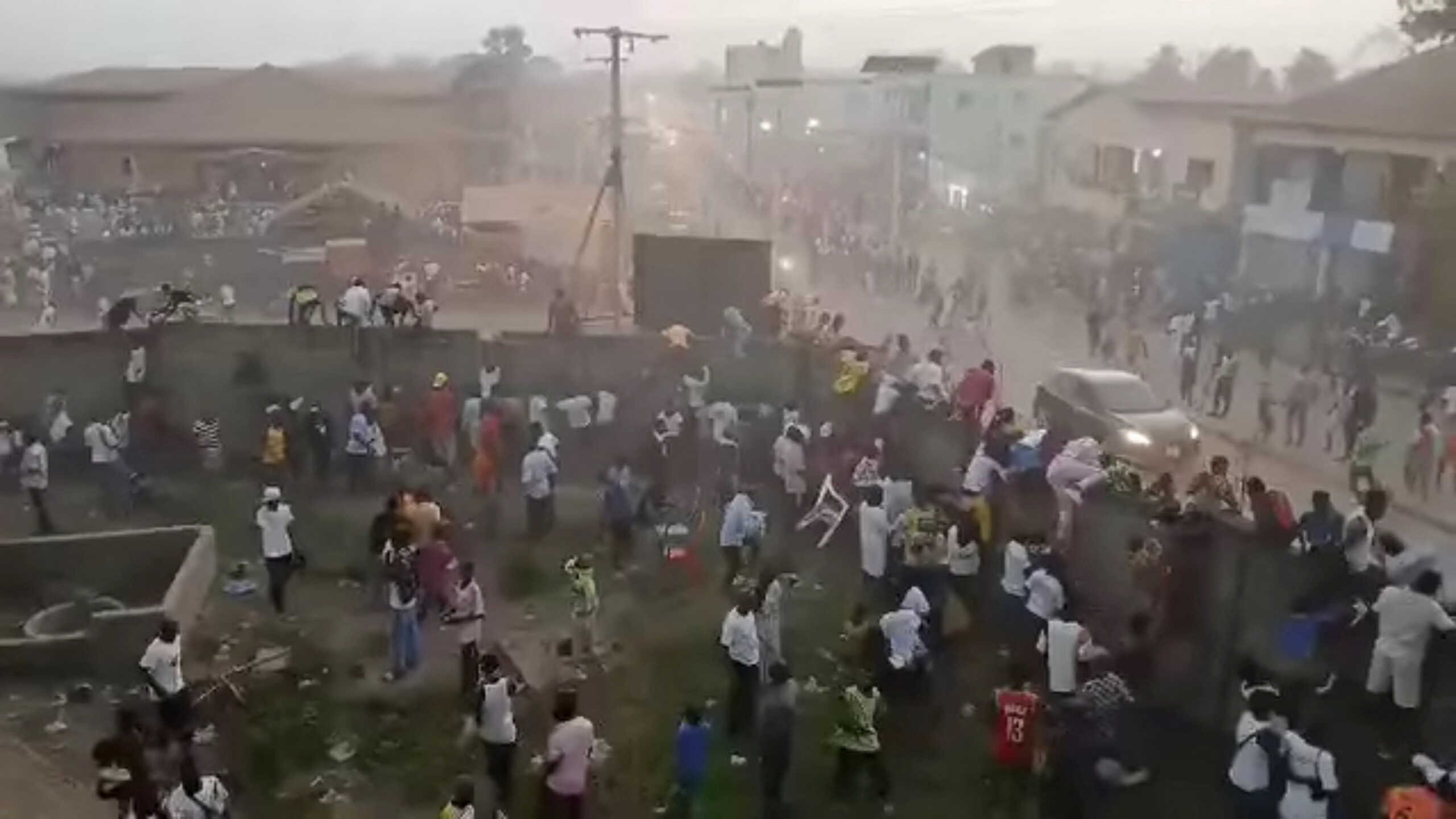 People scramble in Nzerekore, Guinea, where local officials said a deadly stampede ensued at a stadium following fan clashes during a soccer match, December 1, 2024, in this still image obtained from a social media video. Social media via REUTERS THIS IMAGE HAS BEEN SUPPLIED BY A THIRD PARTY. NO RESALES. NO ARCHIVES