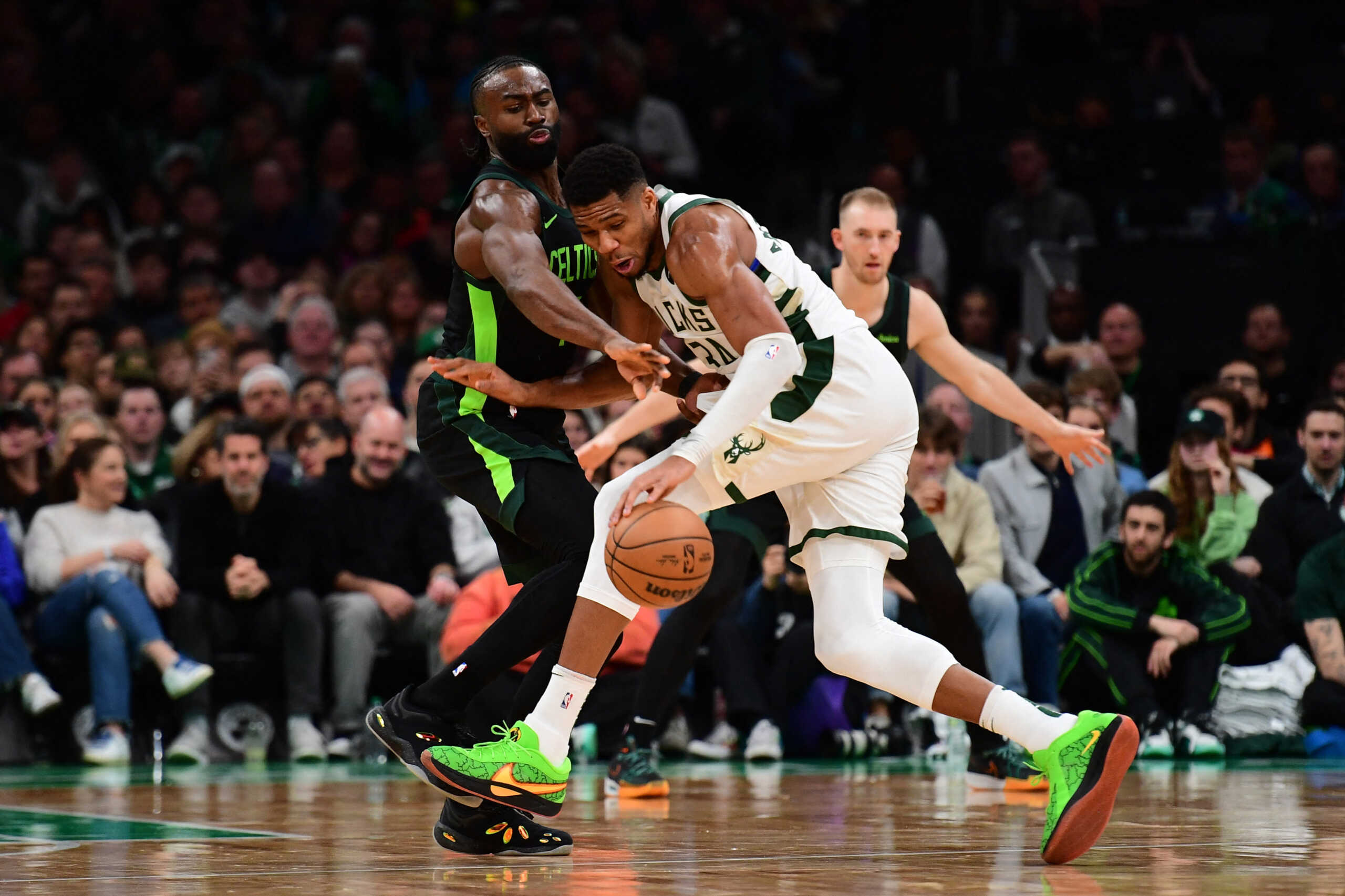 Dec 6, 2024; Boston, Massachusetts, USA;  Boston Celtics guard Jaylen Brown (7) tries to steal the ball from Milwaukee Bucks forward Giannis Antetokounmpo (34) during the second half at TD Garden. Mandatory Credit: Bob DeChiara-Imagn Images