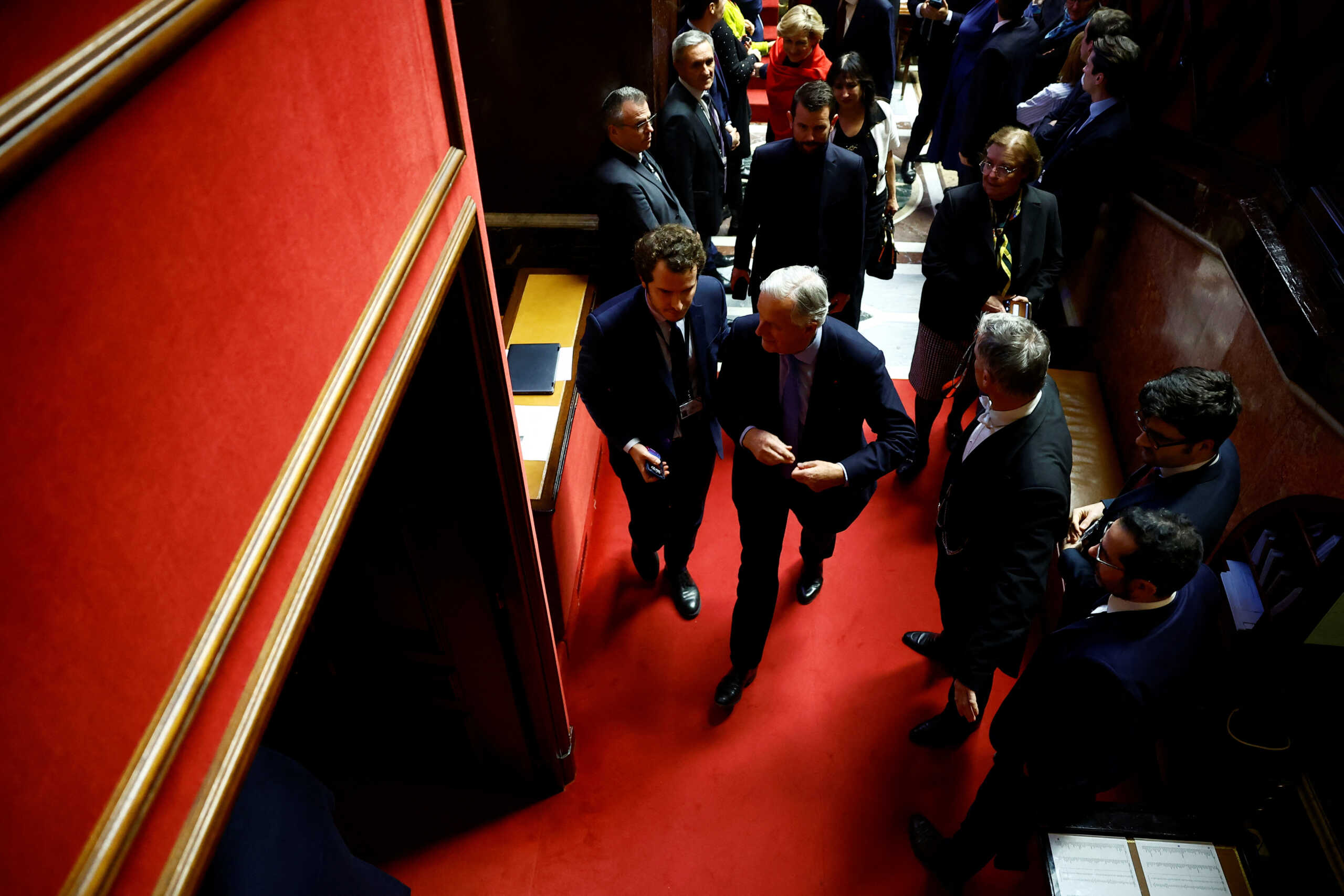 French Prime Minister Michel Barnier leaves after the result of the vote on the first motion of no-confidence against the French government, tabled by the alliance of left-wing parties the "Nouveau Front Populaire" (New Popular Front - NFP), after the use by French government of the article 49.3, a special clause in the French Constitution, to push the budget bill through the National Assembly without a vote by lawmakers, at the National Assembly in Paris, France, December 4, 2024. REUTERS