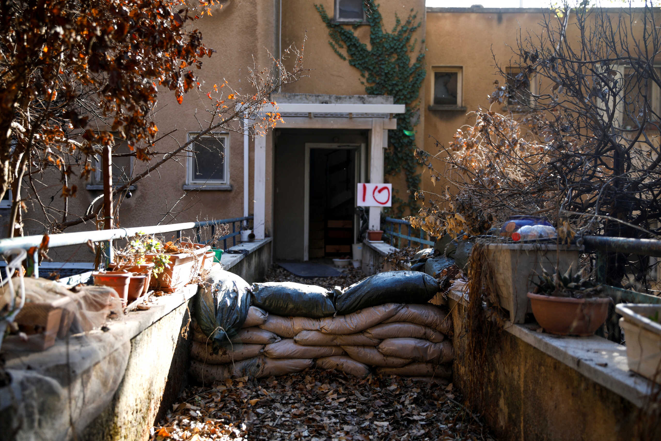 Sandbags lie near an entrance to a building, in a damaged neighbourhood near the Israel-Lebanon border, following the ceasefire between Israel and Iran-backed group Hezbollah, in Manara, northern Israel, December 2, 2024. REUTERS